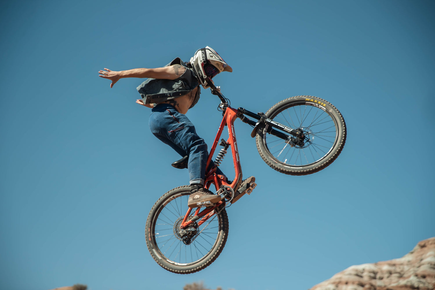 person on bike with no hands on the handlebars