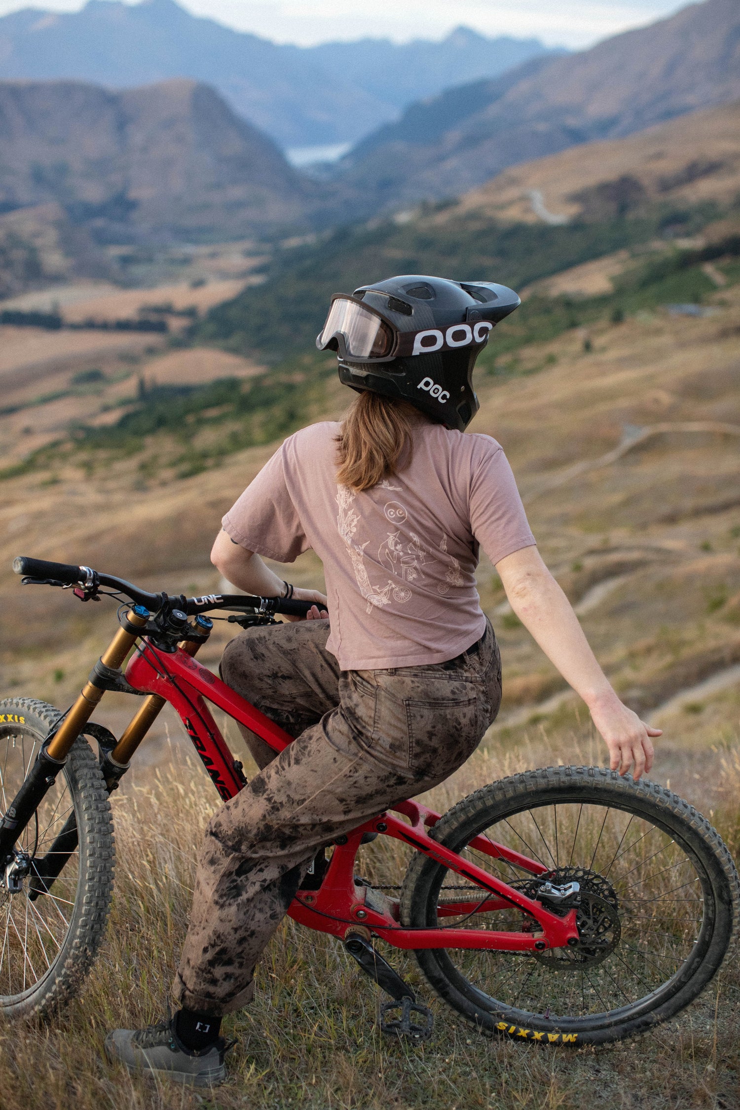 person on a mountain bike with a full face helmet on