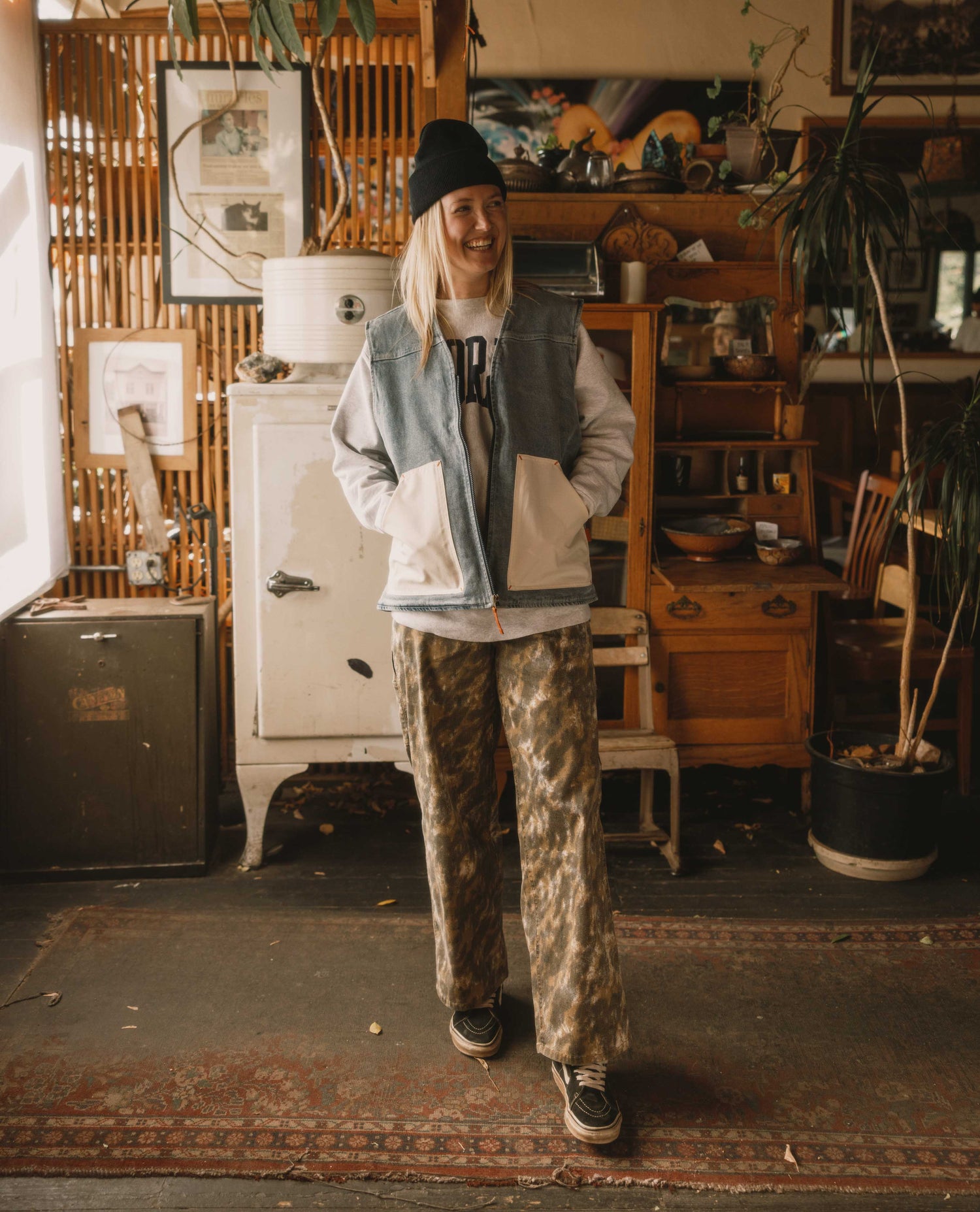 Person standing in a room with vintage furniture and decor