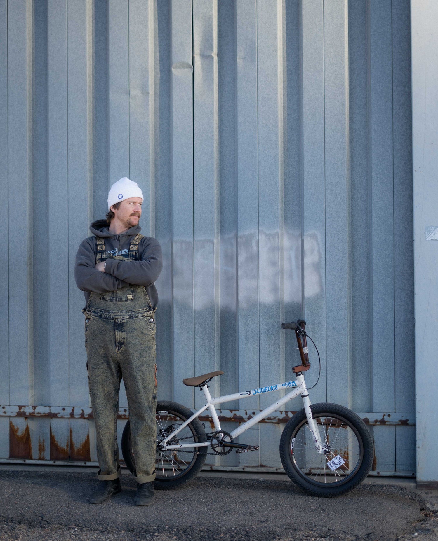 Myles in overalls with BMX bike