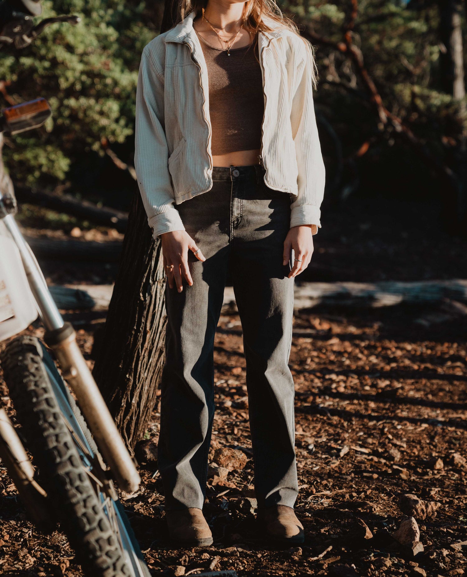 woman standing by motorcycle