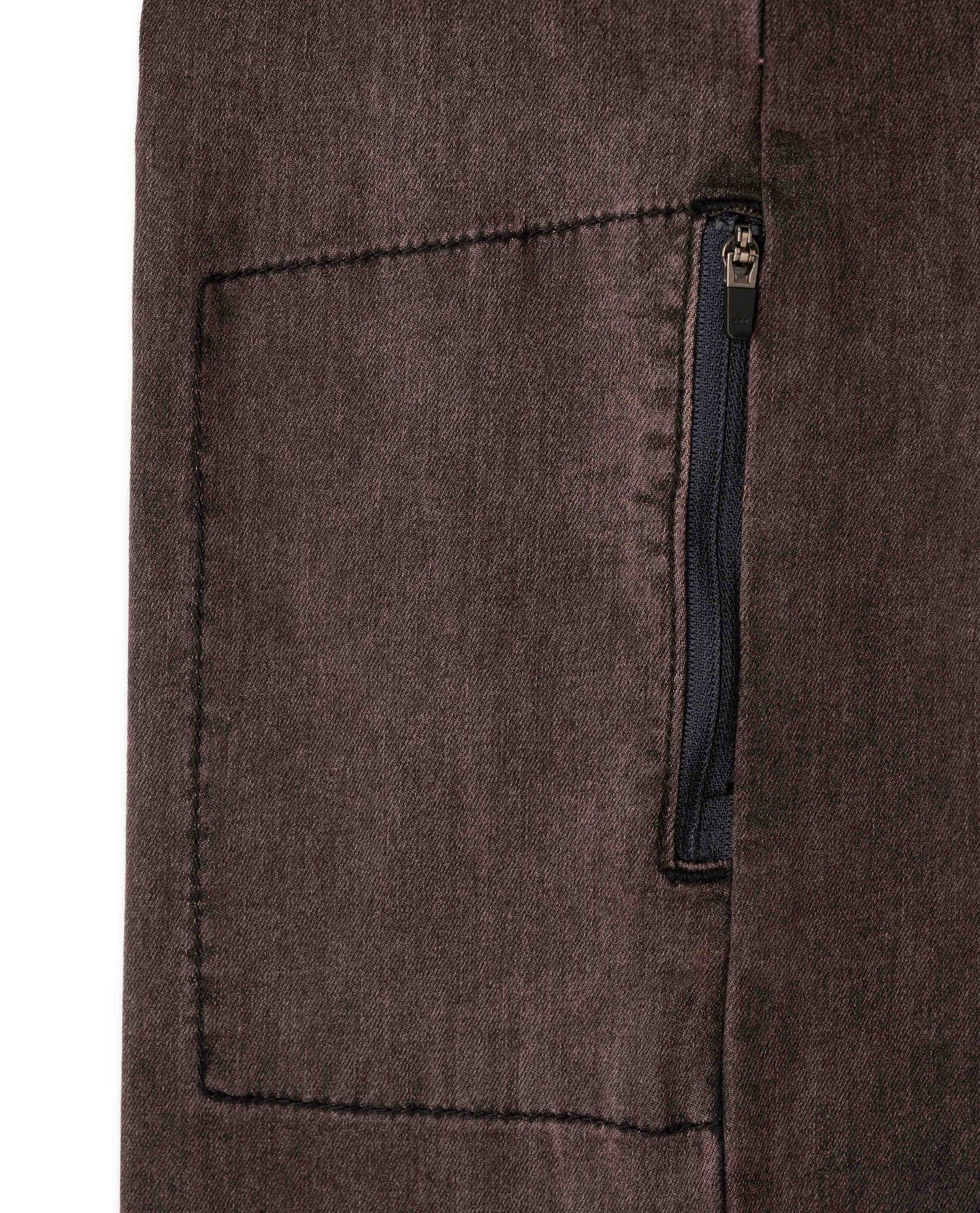 Close-up of a brown fabric pocket with a zipper on a white background