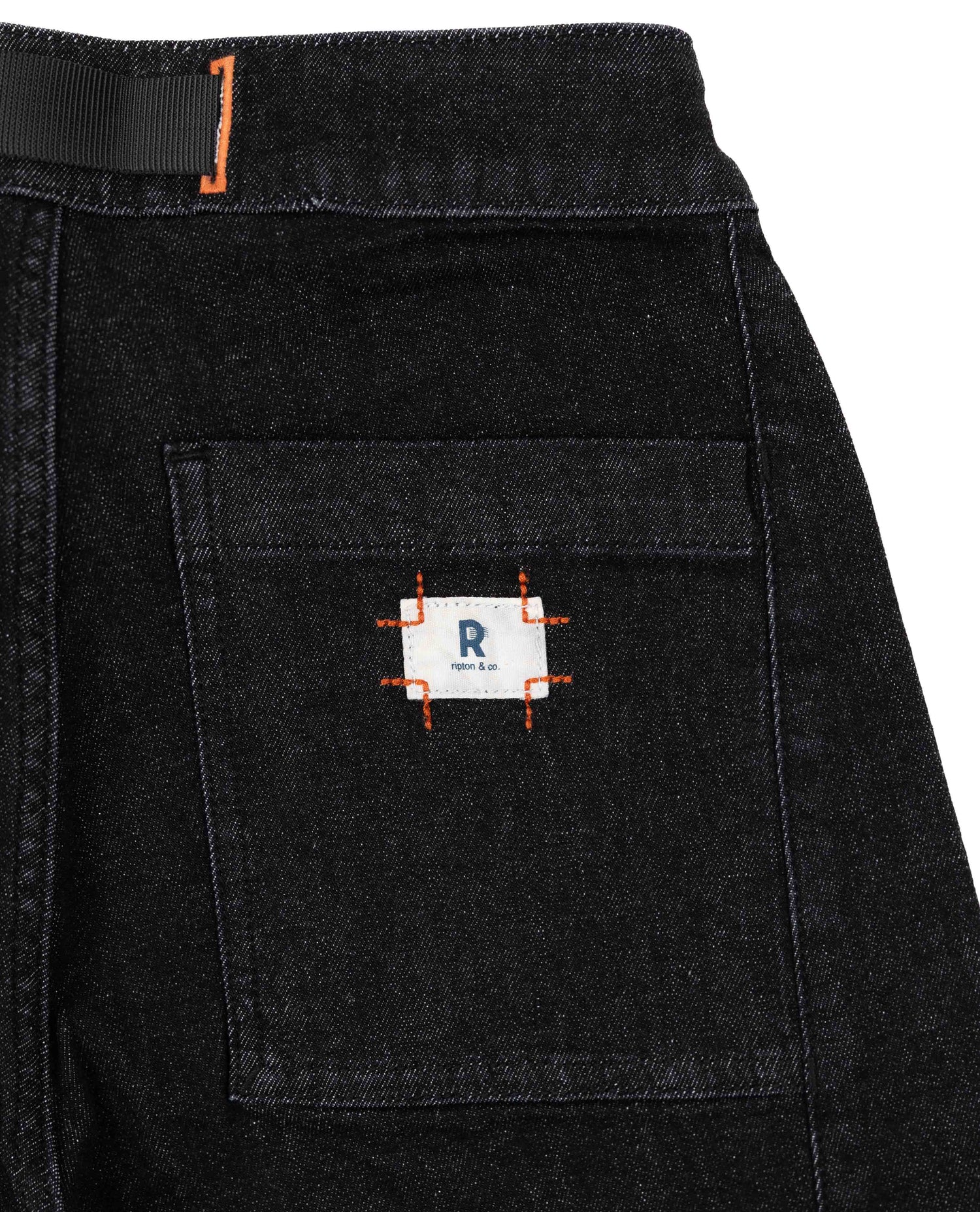 Black denim shorts with a brand logo on the pocket against a white background