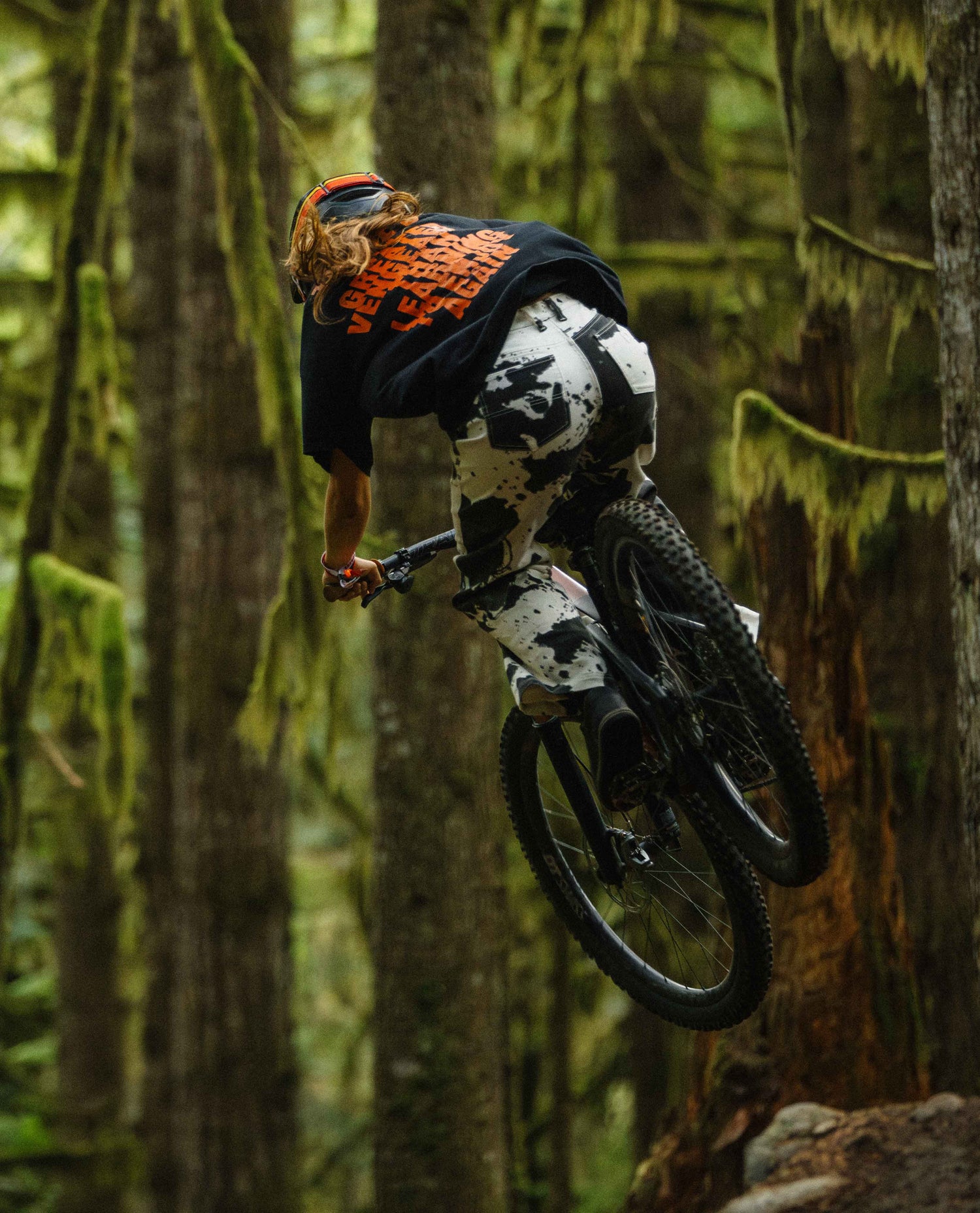 Person riding a mountain bike through a forest