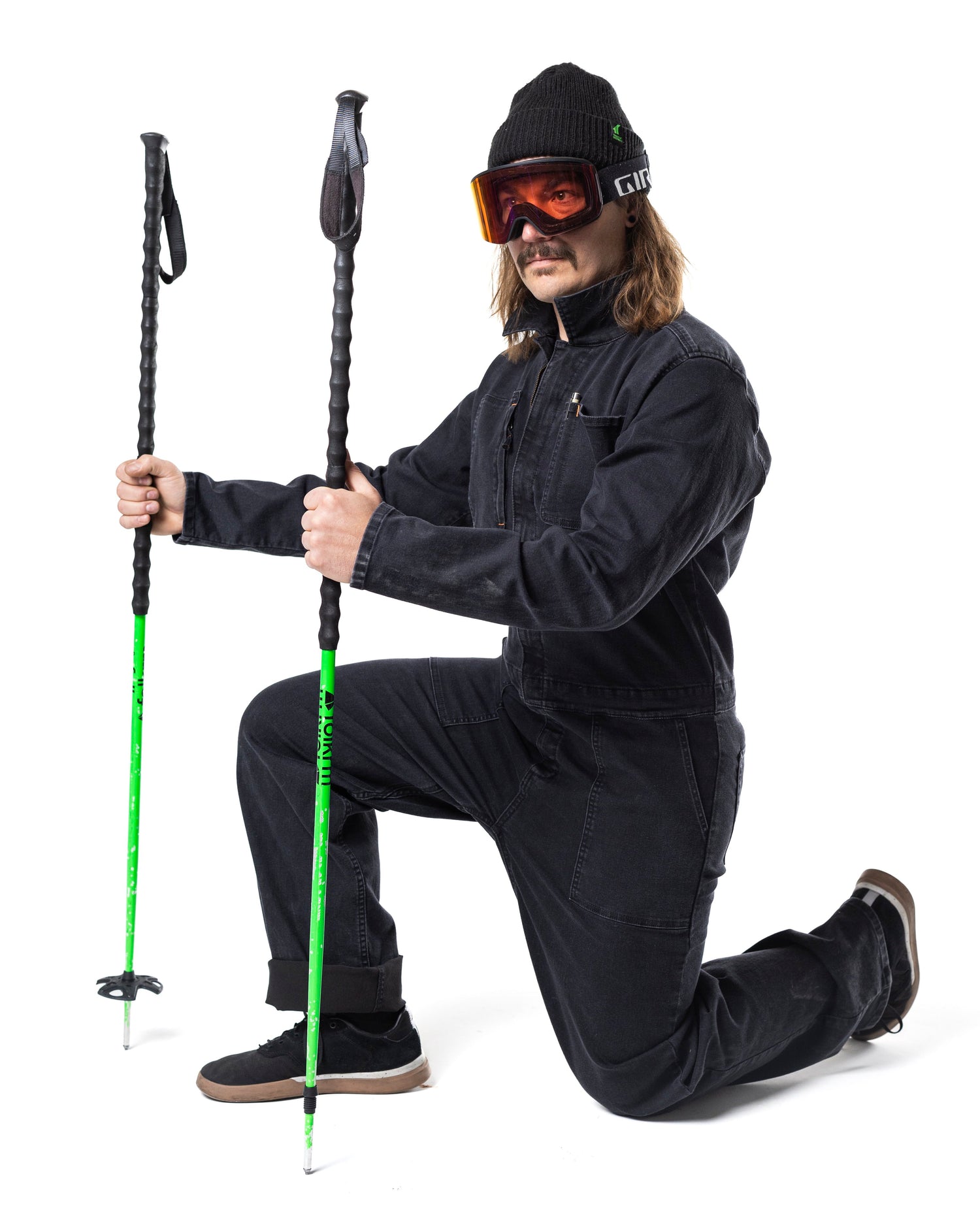 Guy with ski poles in a coverall