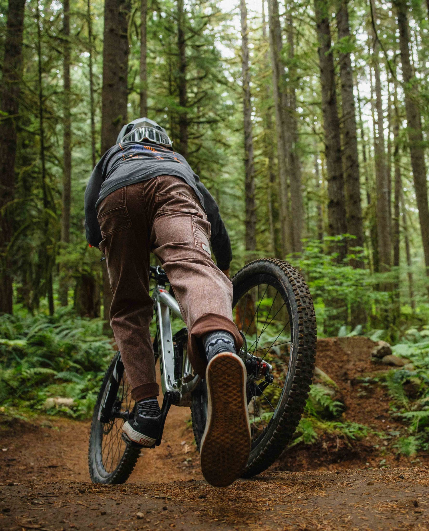Person riding a mountain bike on a trail in a forest