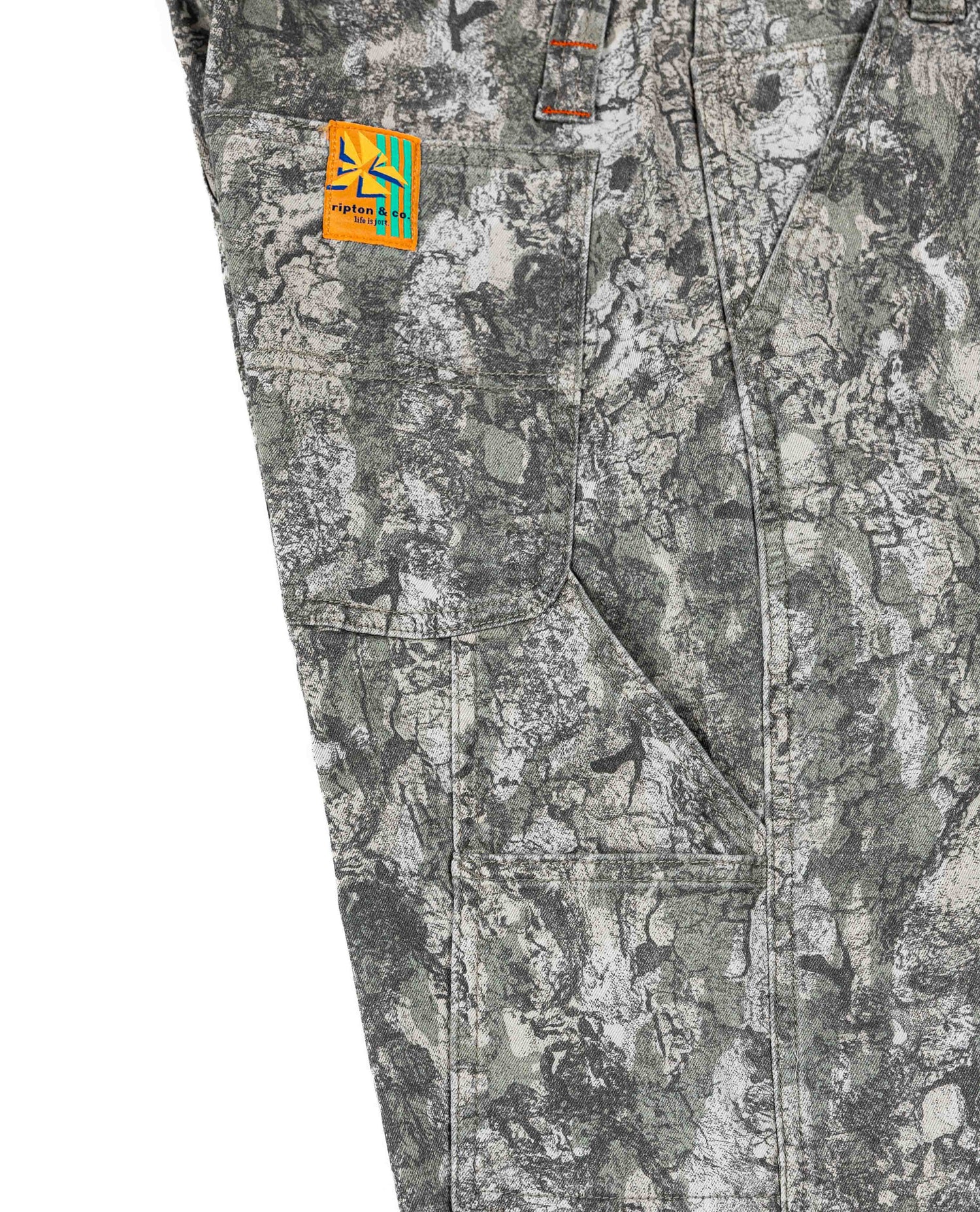 Camouflage pants with a visible brand logo on a white background