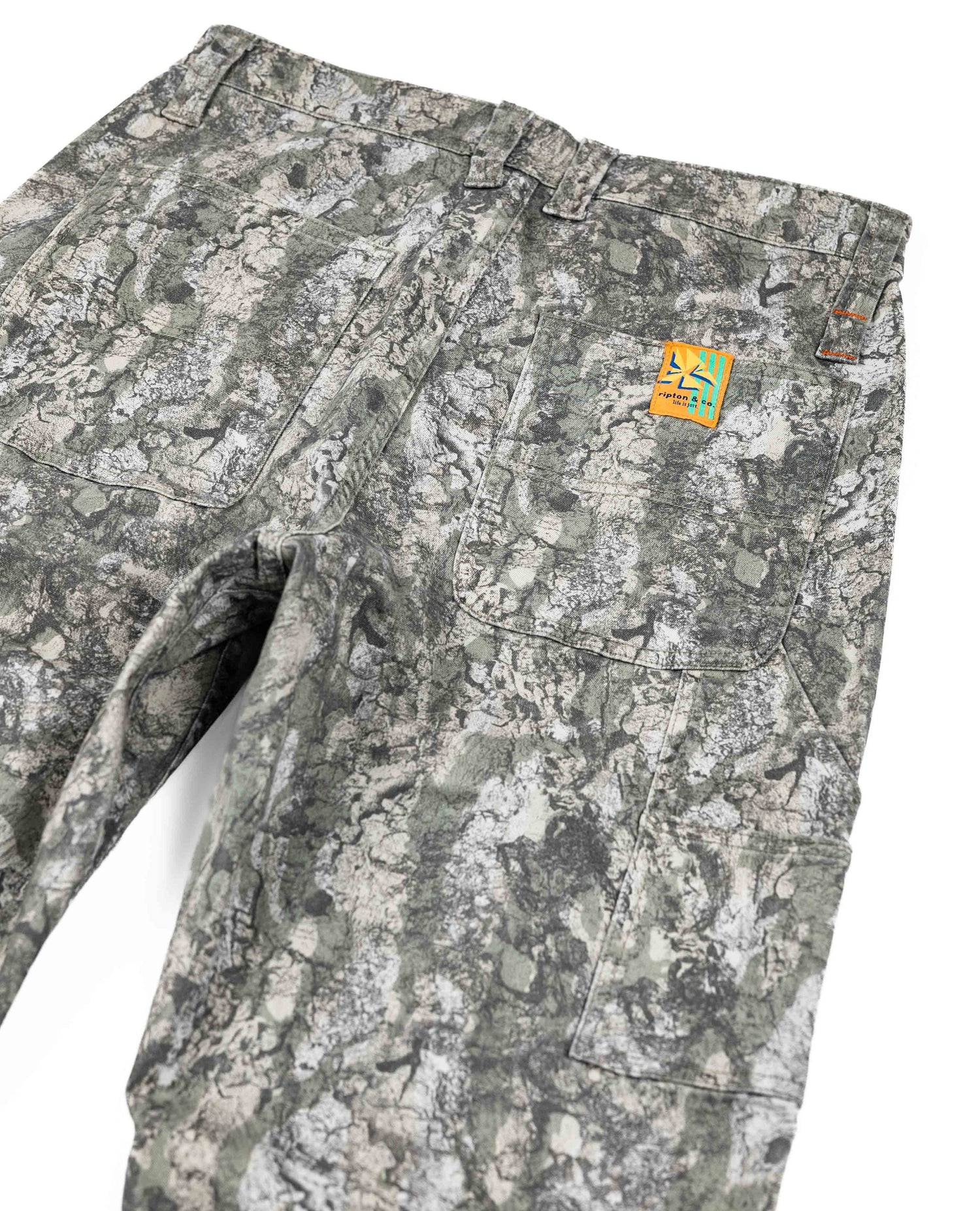 Camouflage pants with a brand logo on a white background