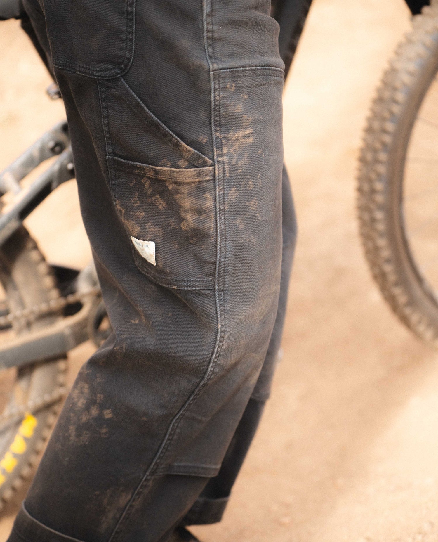 Rivers mountain biking in black utility pants details of pockets