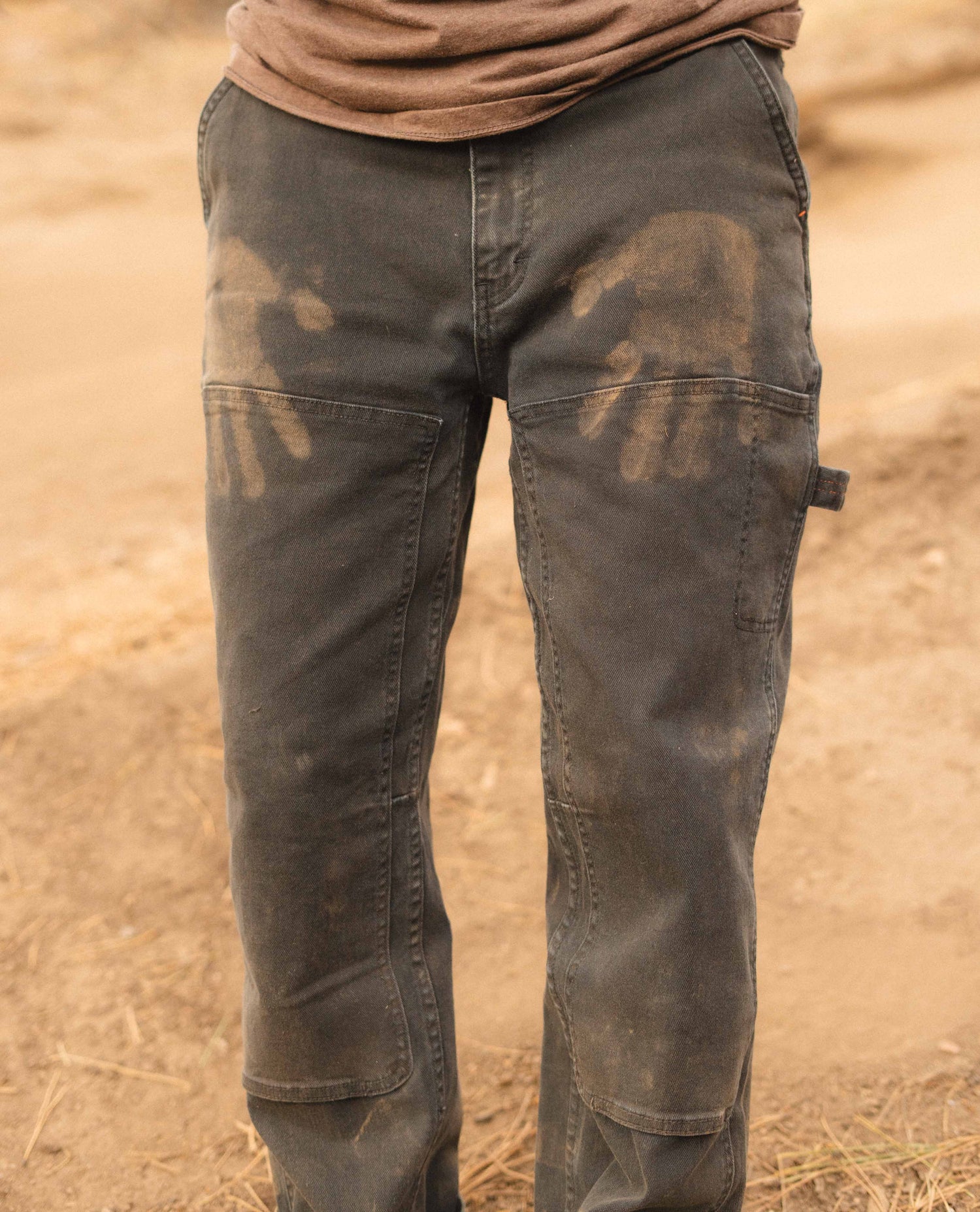 Rivers mountain biking in black utility pants detail