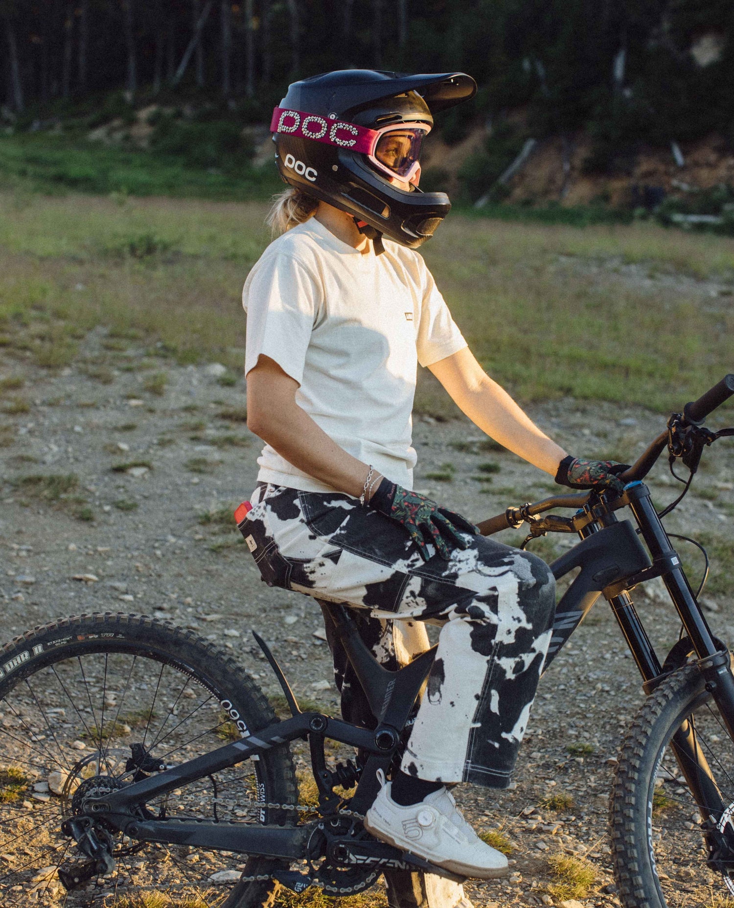 Person on a bike wearing a helmet and gloves in an outdoor setting