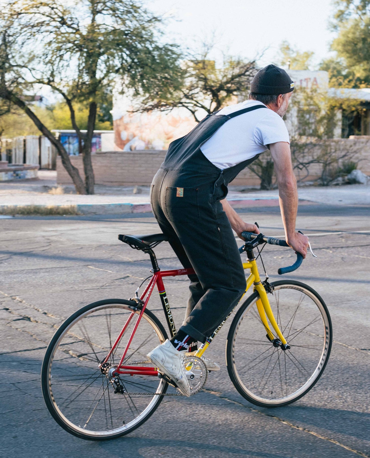 person wearing overalls on bike