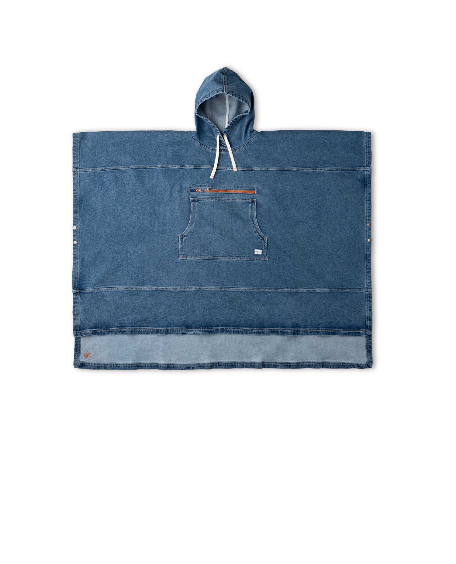 A blue denim poncho with a hood, snap buttons, and a zippered pocket, laid flat on a white background.