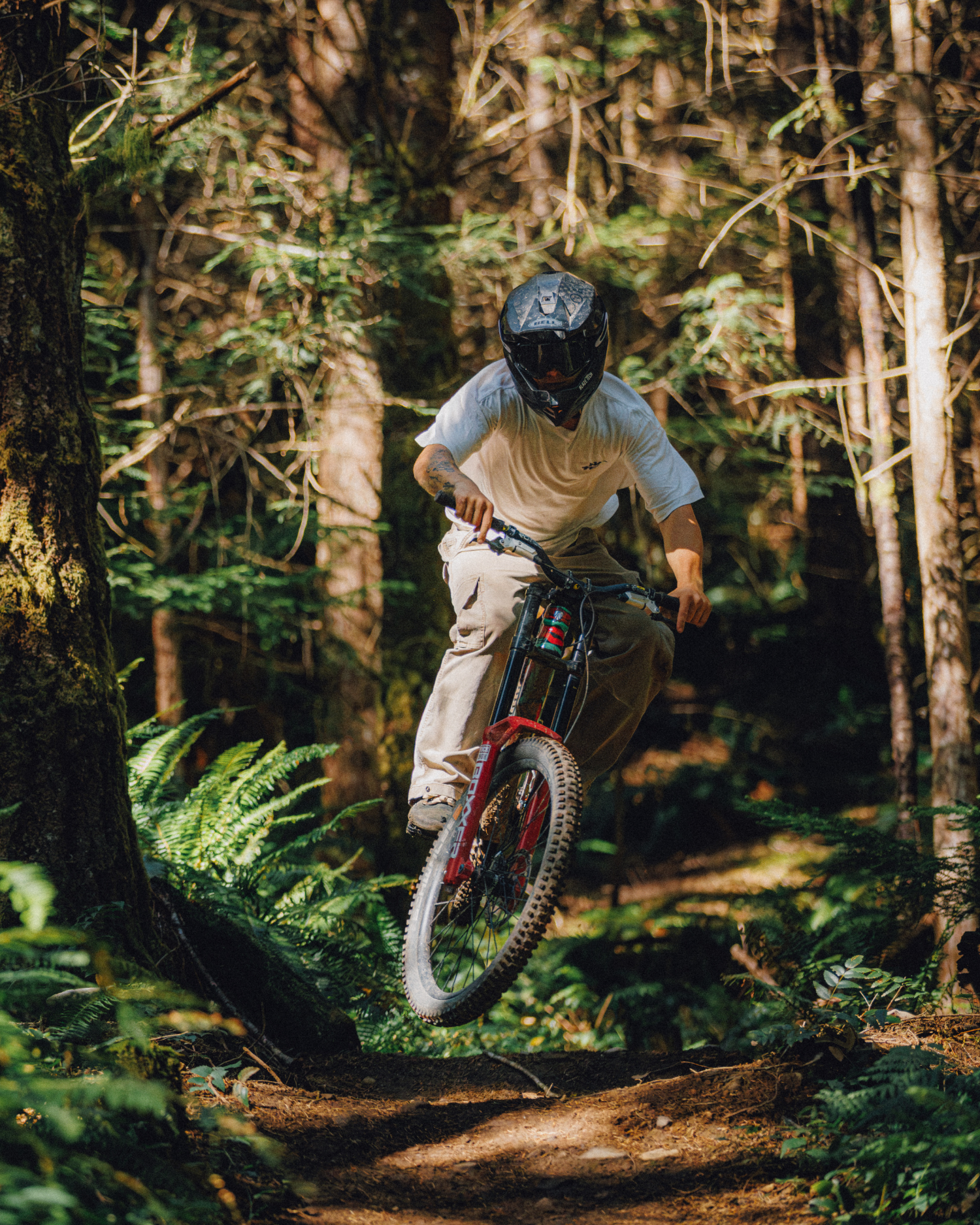 Mountain biker wearing relaxed brown cargo pants on a forest trail