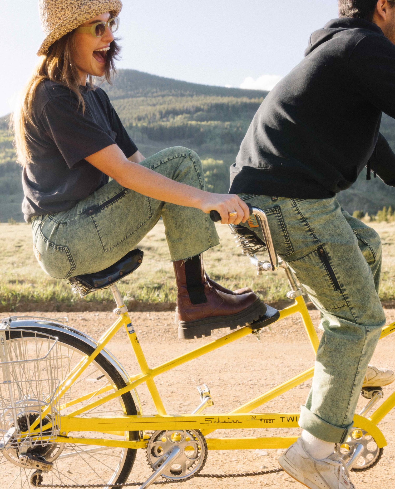 couple riding tandem bike in superlite jeans