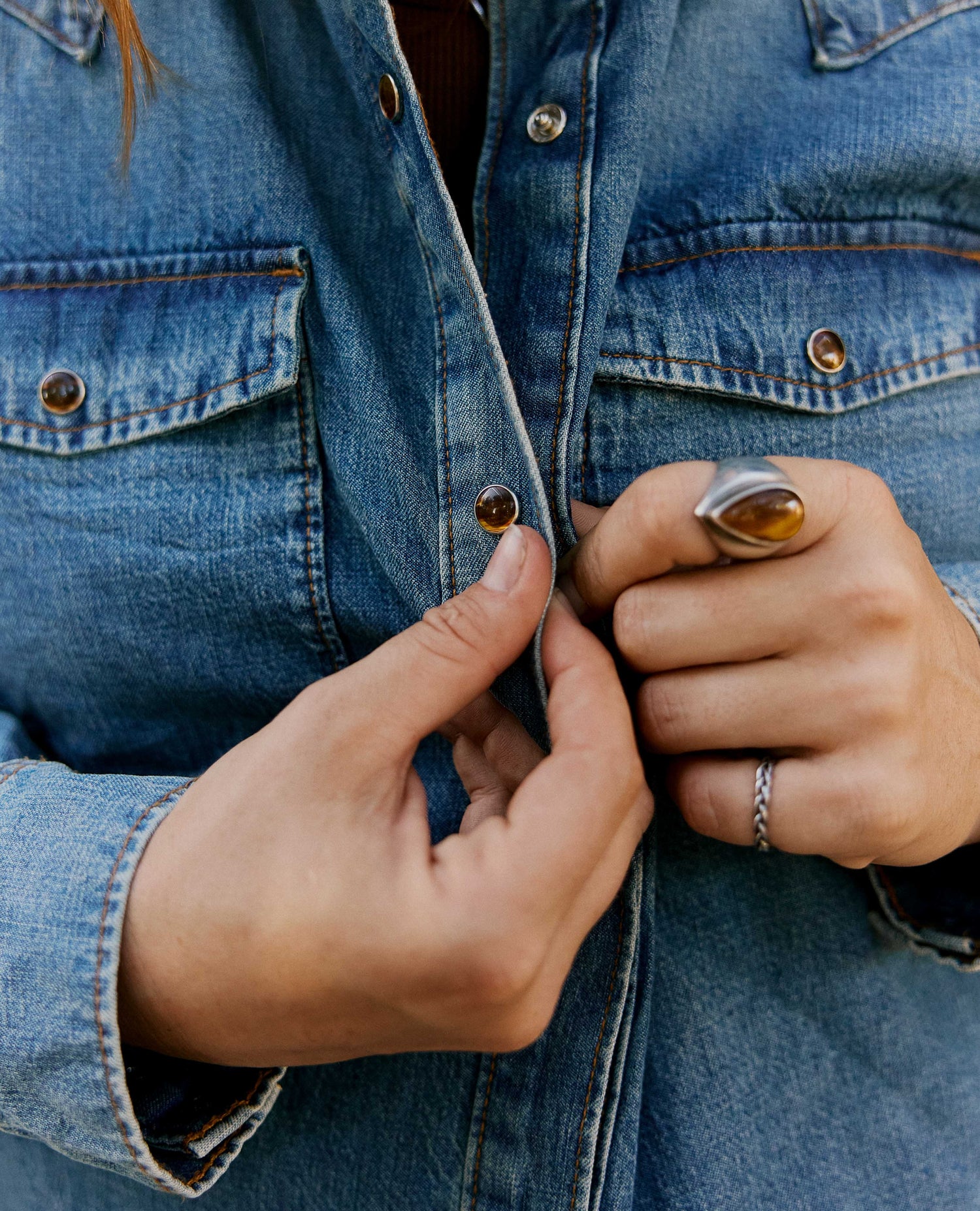 Close up of snaps on a denim shirt