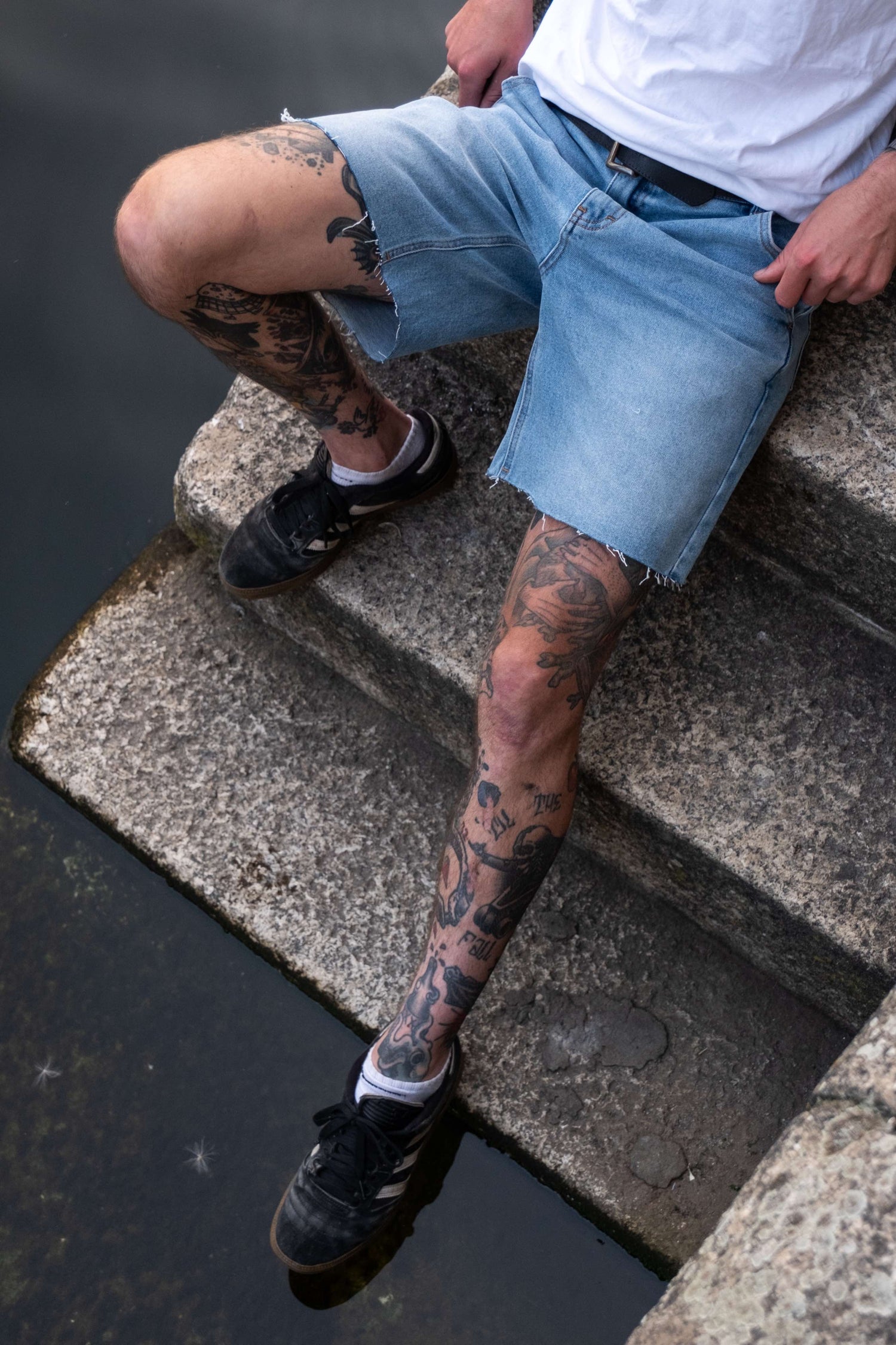 Jorts on tattooed legs