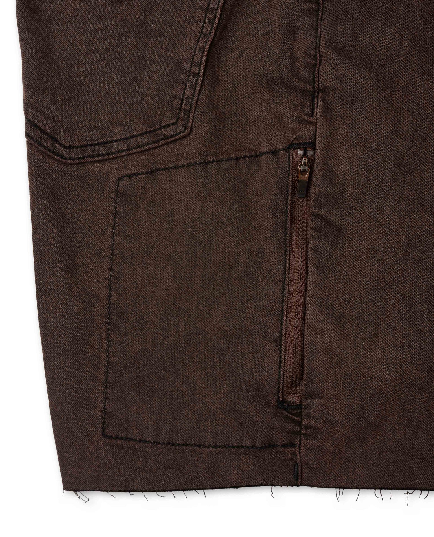Close-up of a brown jacket with a pocket and zipper detail.