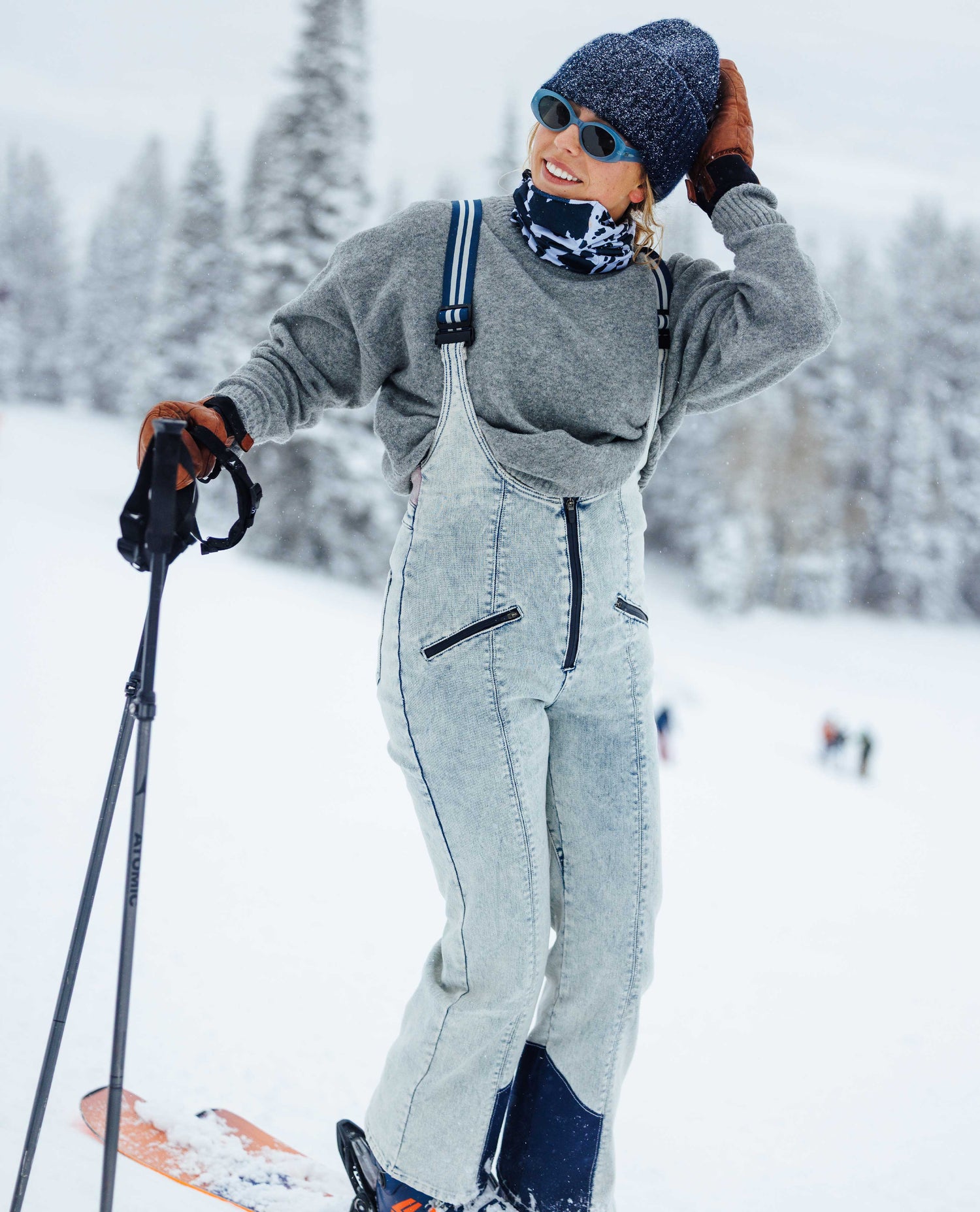 Person in gray ski outfit with snow equipment on a snowy landscape