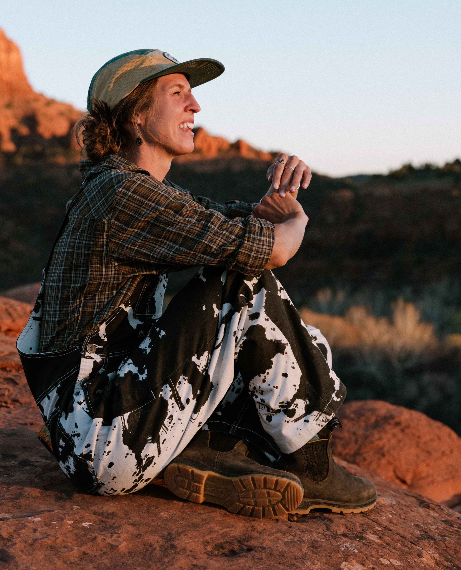 Person sitting on a rock with a scenic background