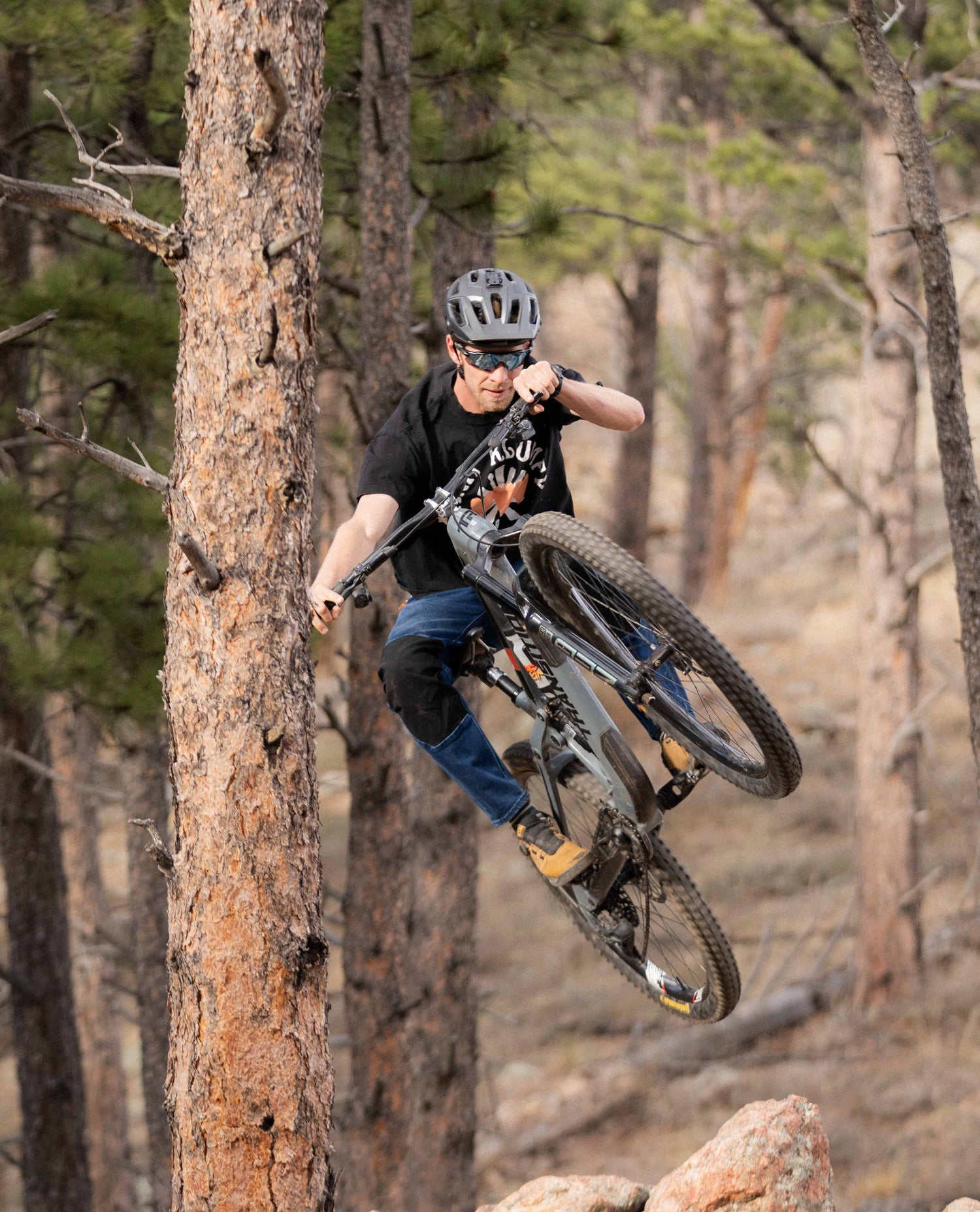 Hitting a jump in Men's Denim Bike Pant