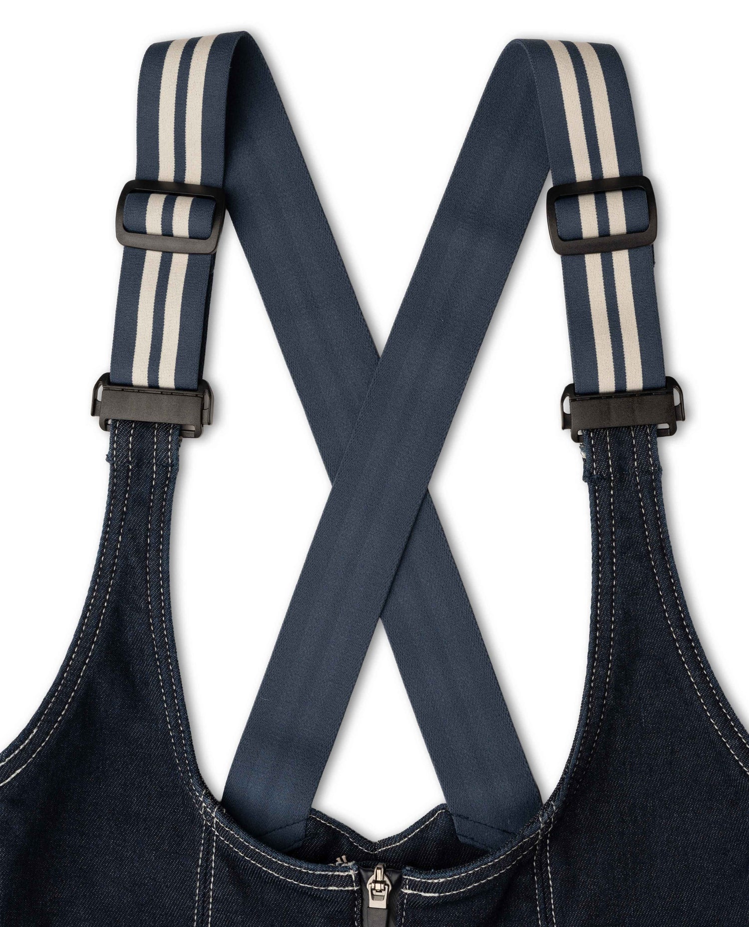 Dark blue denim overalls with striped suspenders on a white background