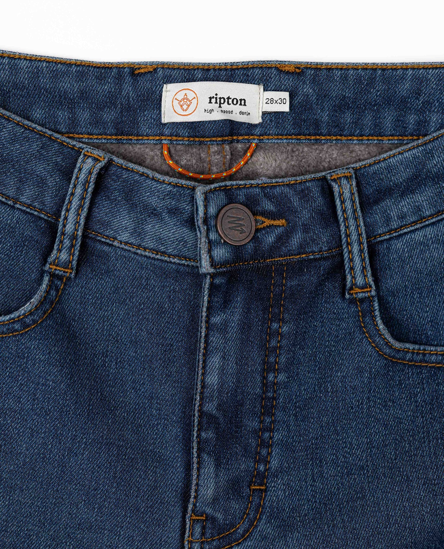 Close-up of blue jeans with a Ripton label on a white background