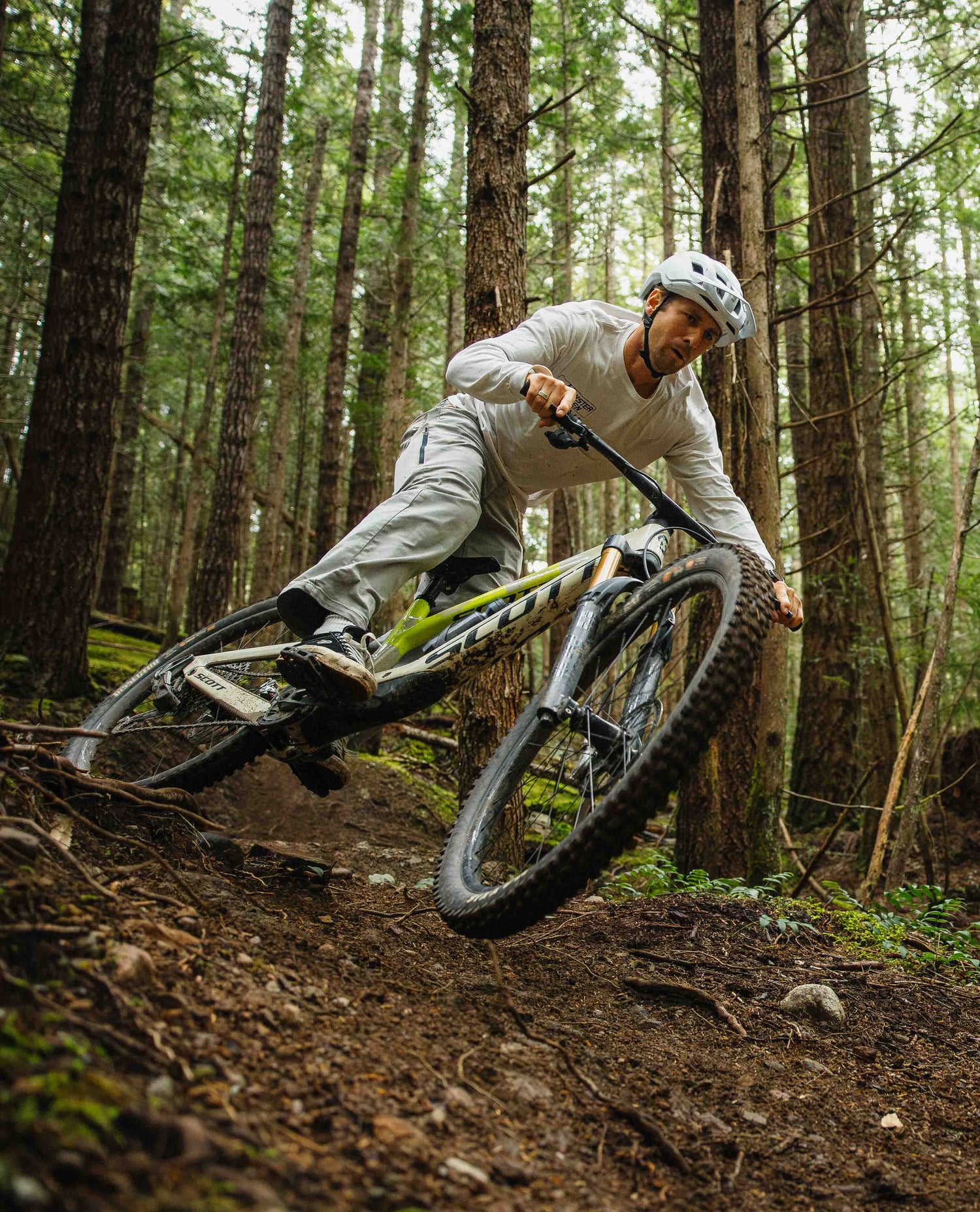 Person riding a mountain bike through a forest