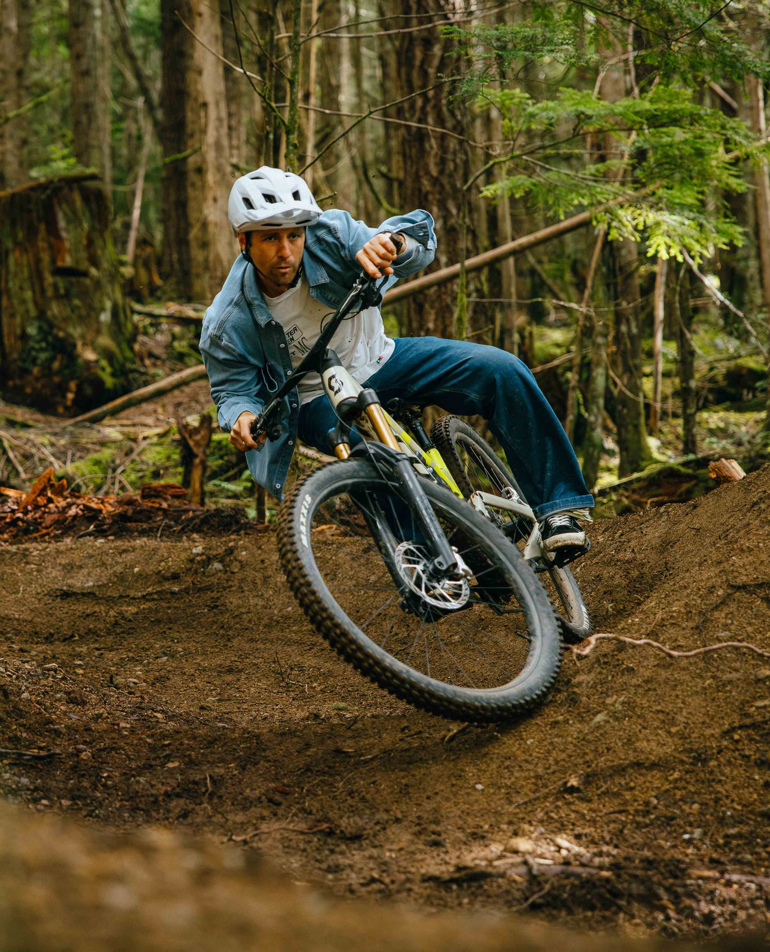 Man riding a mountain bike on a trail in a forest