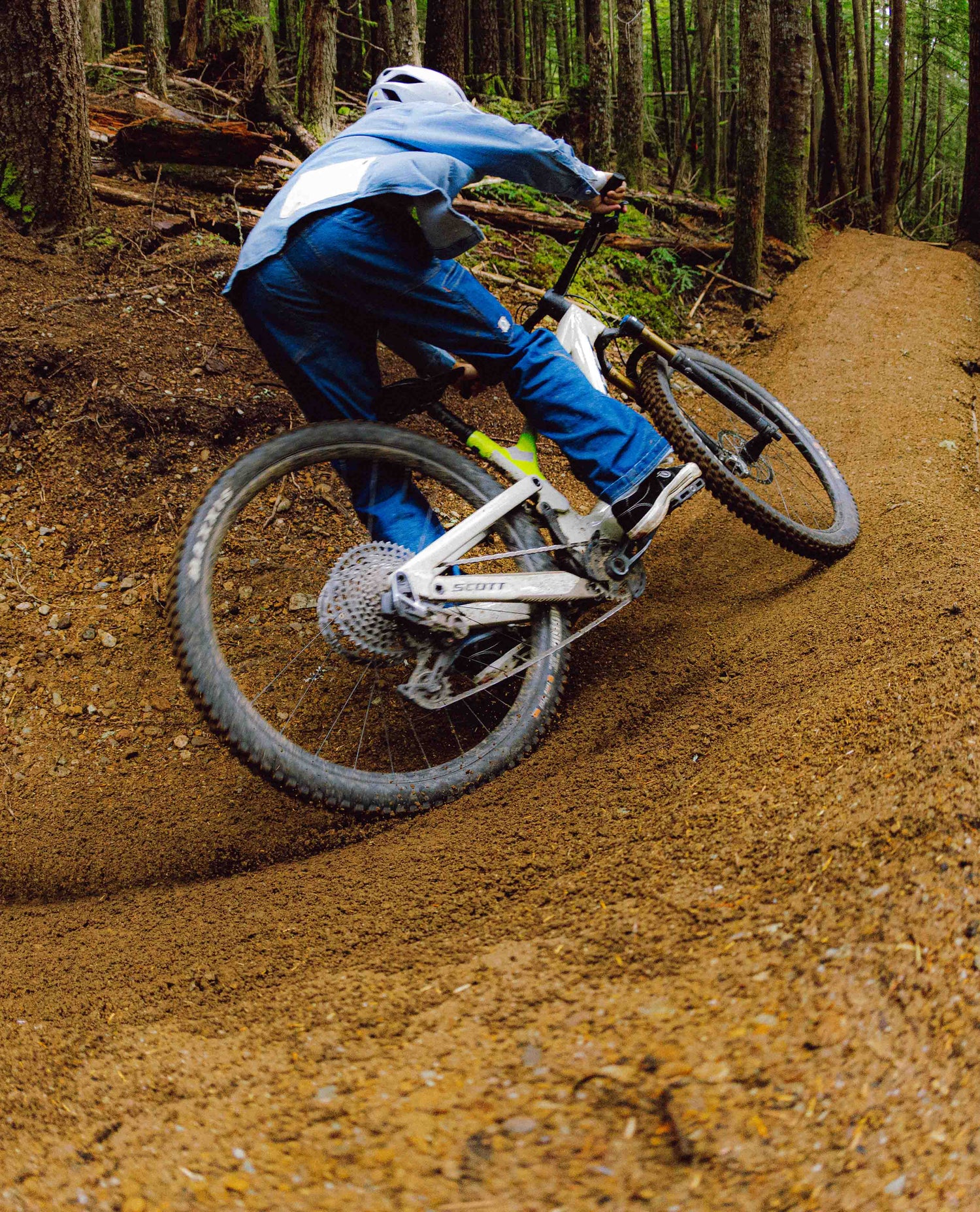 Person riding a mountain bike on a dirt trail in a forest