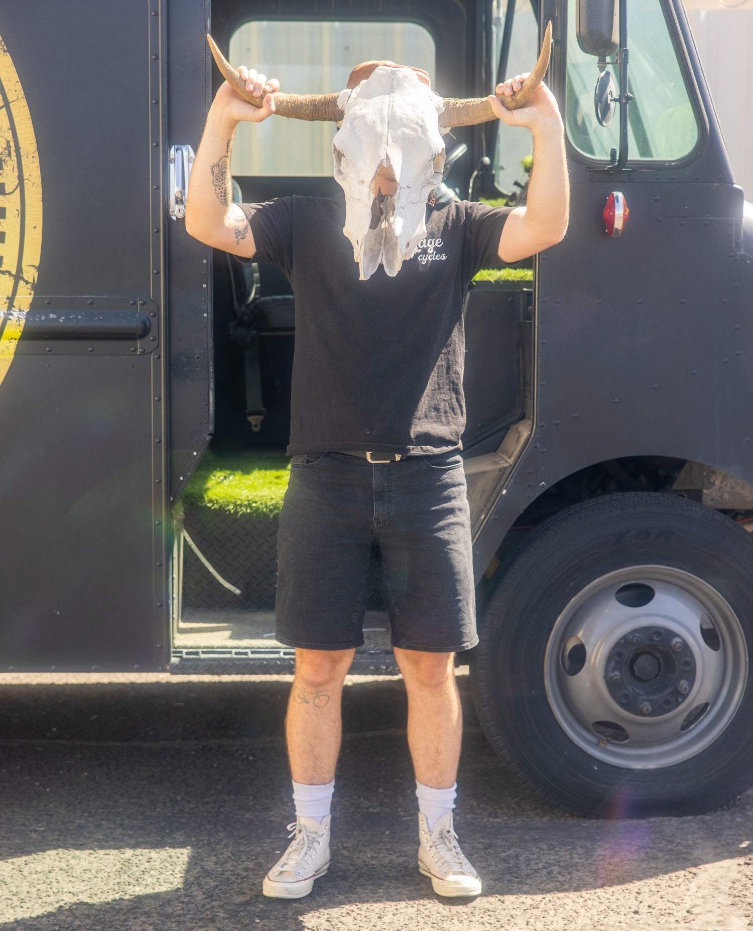 Person with long horns standing in front of a black food truck