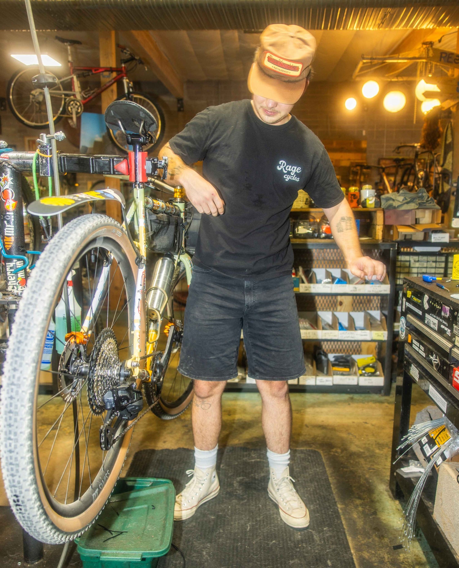 Person working on a bicycle in a workshop setting