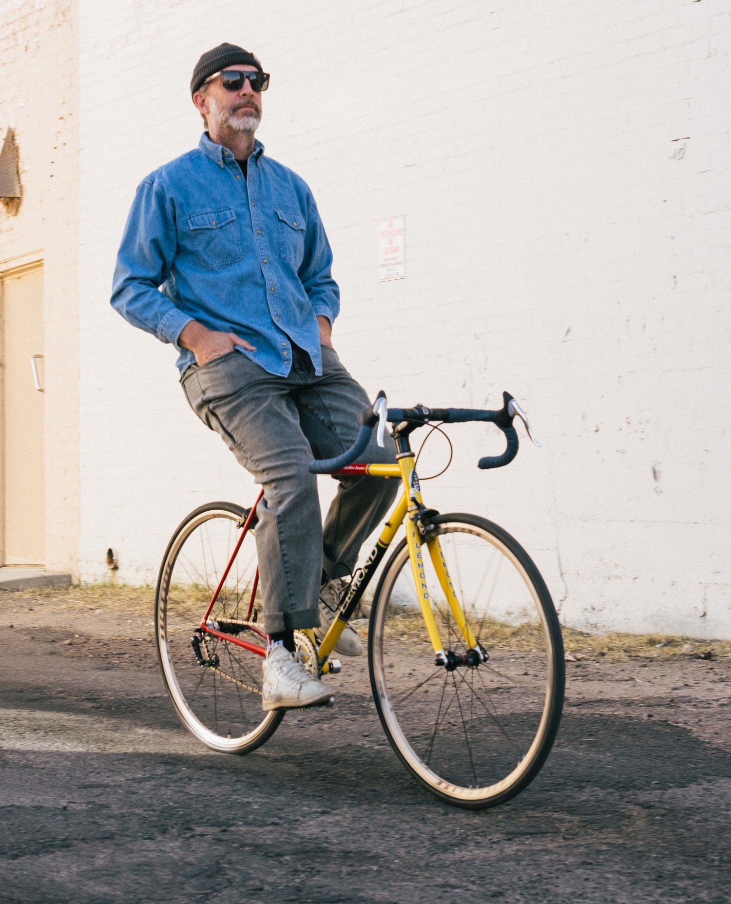 Curtis on a bike in Turtle Superlite Jeans