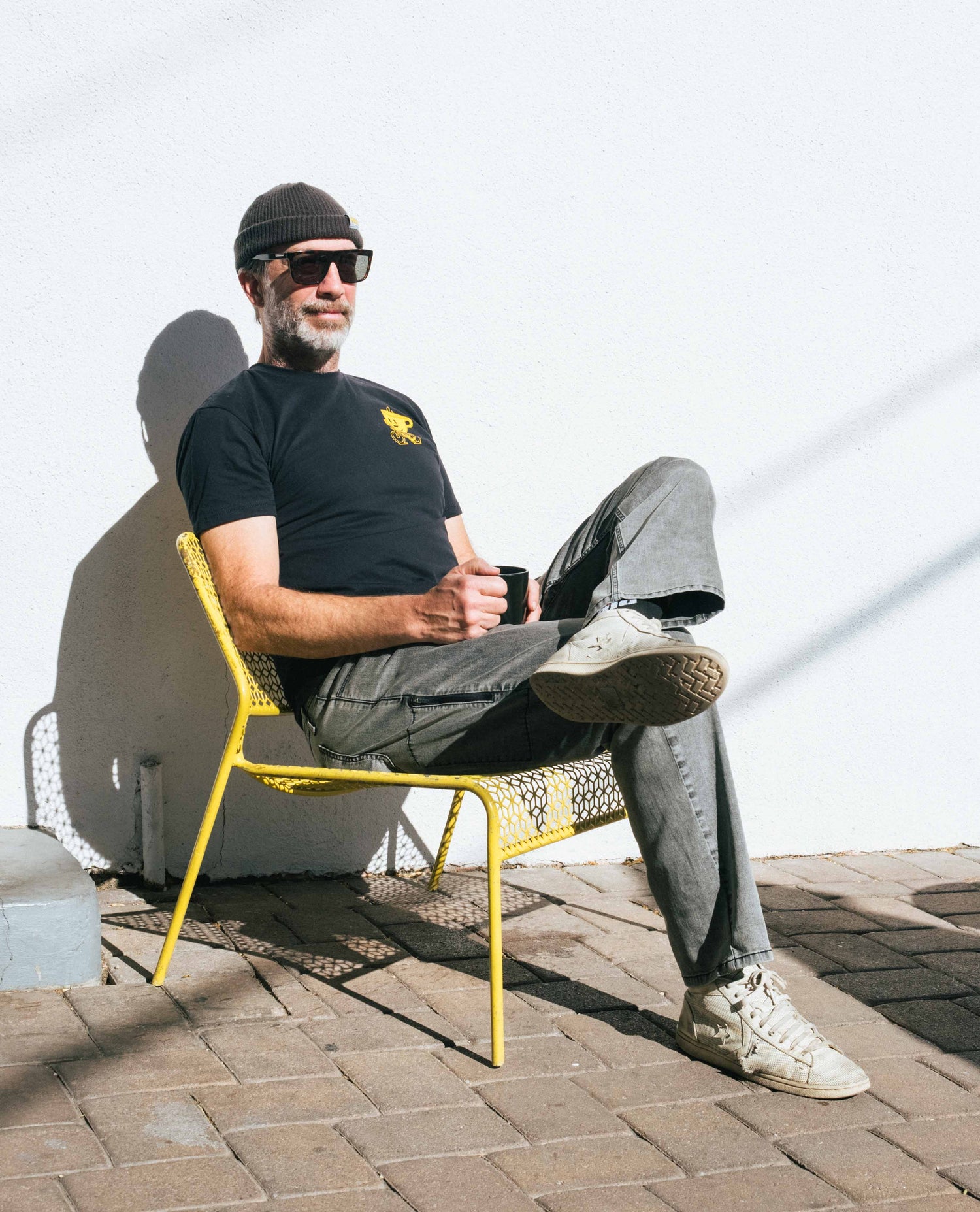 Curtis sitting on a yellow chair in Turtle Superlite Jeans