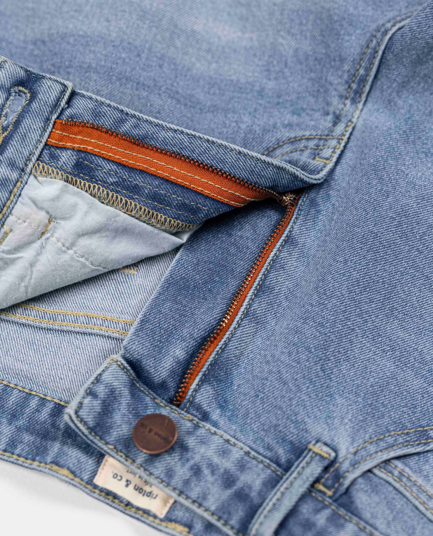 A close up of a zipper on a pair of Ripton jorts. 