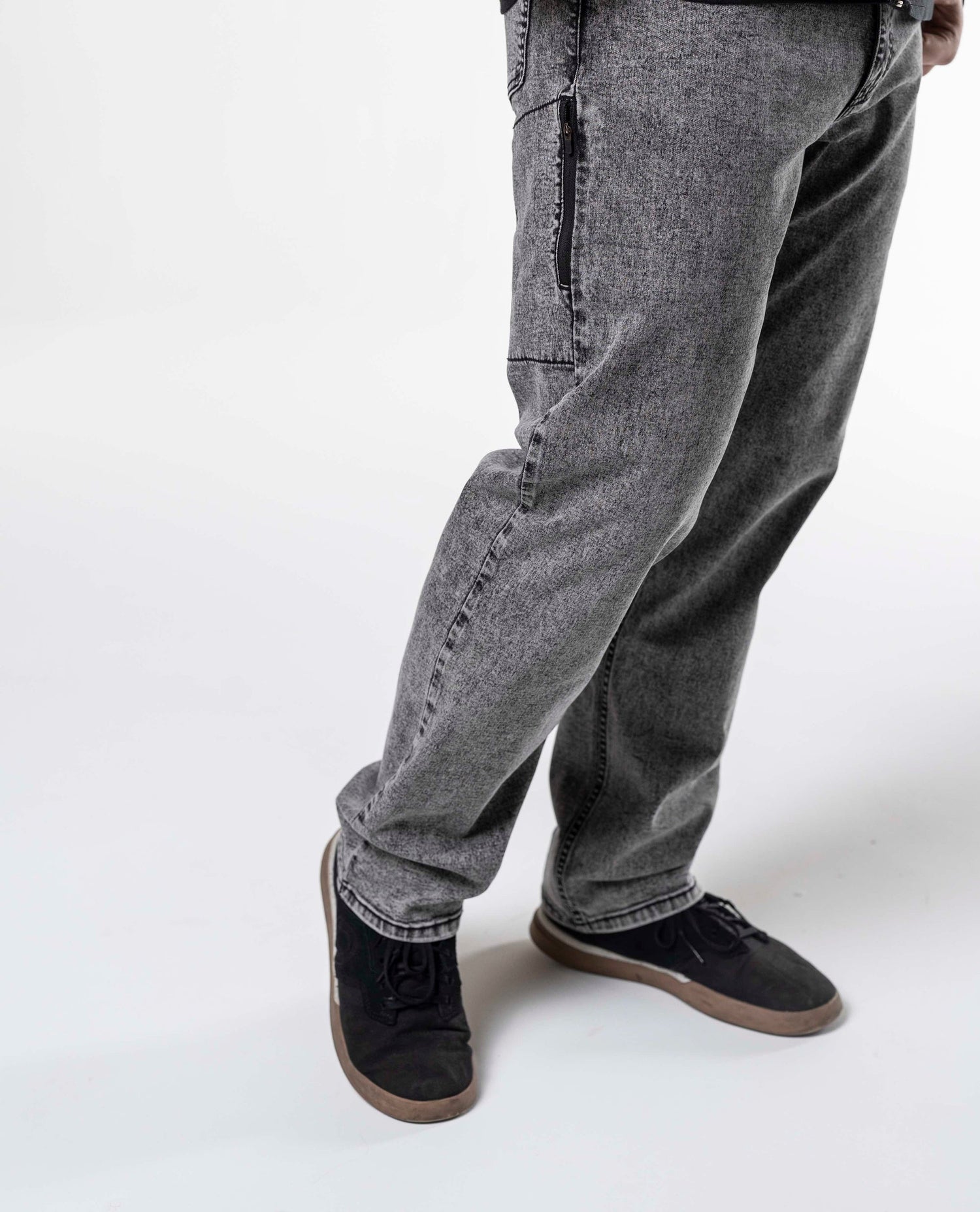 An on body studio photo of a man wearing grey Ripton jeans. 