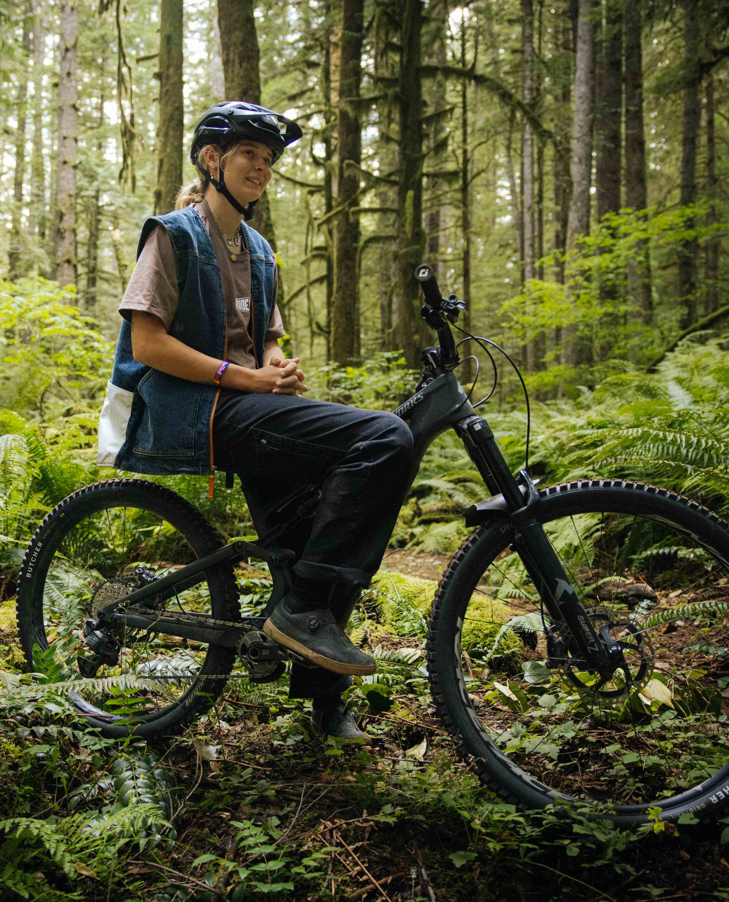 Person with a mountain bike in a forest setting