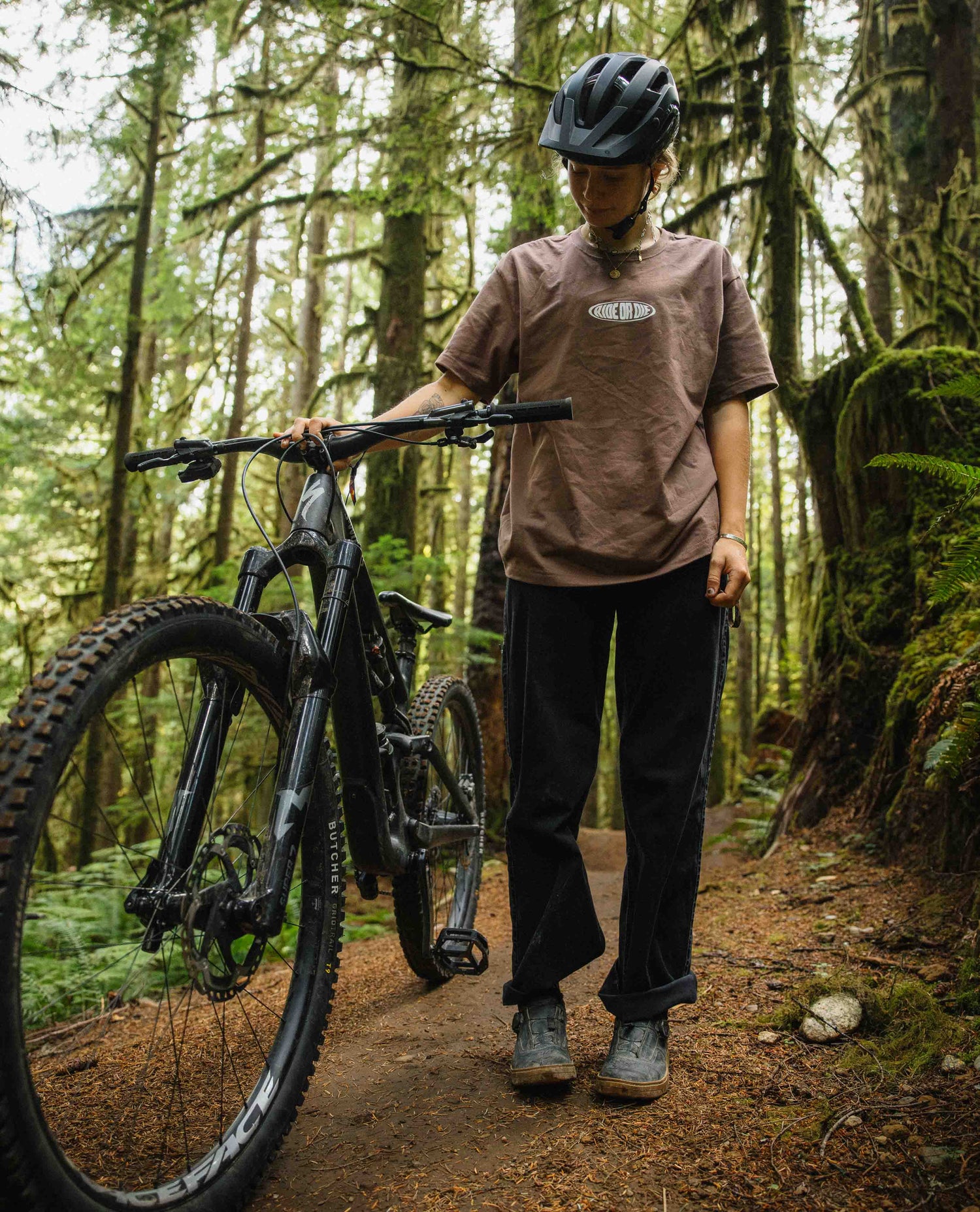 Person with a mountain bike in a forest setting