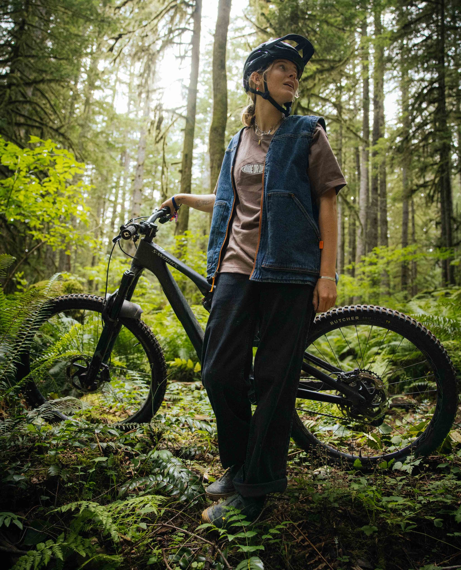 Person with a bicycle in a forest setting