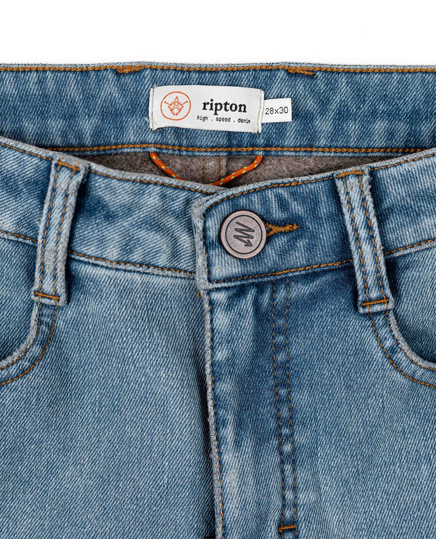 Close-up of blue jeans with a brand label on a white background