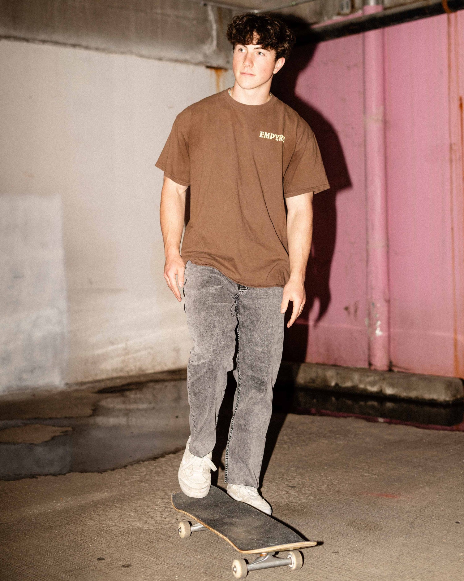 Guy posing with a skateboard