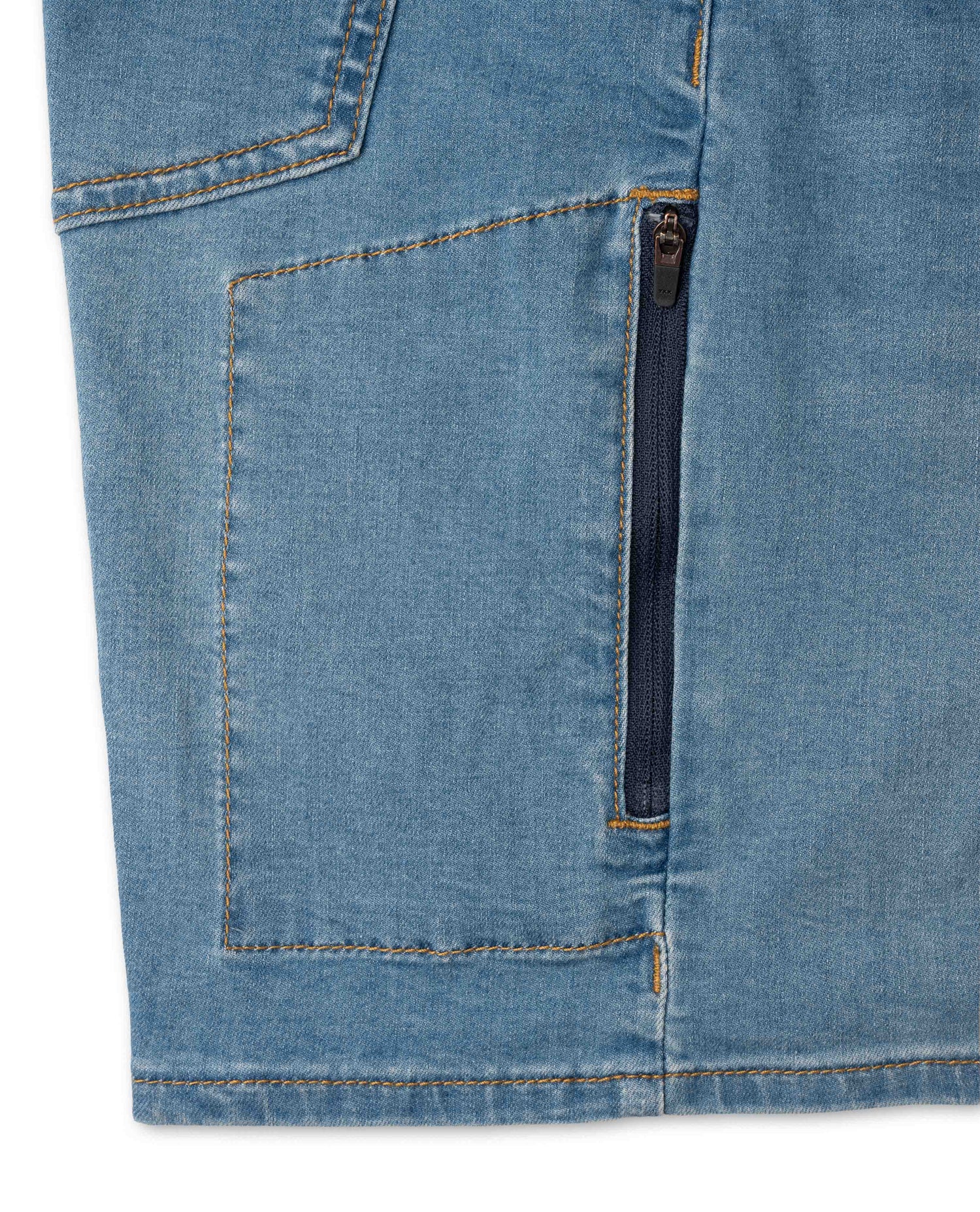 Close-up of blue denim shorts with a zipper pocket on a white background