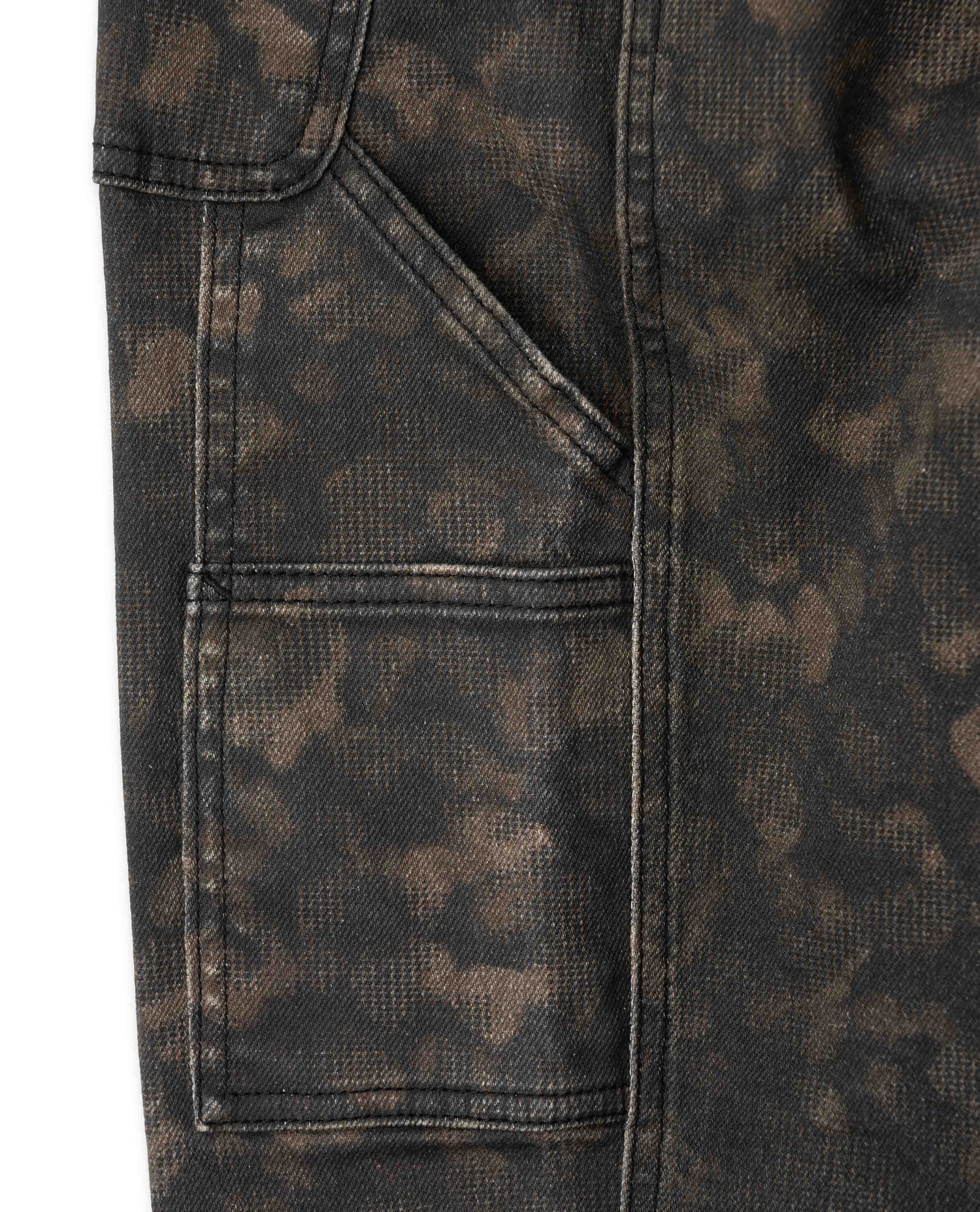 Close-up of a dark brown and black mottled patterned fabric with a pocket detail on the left side.