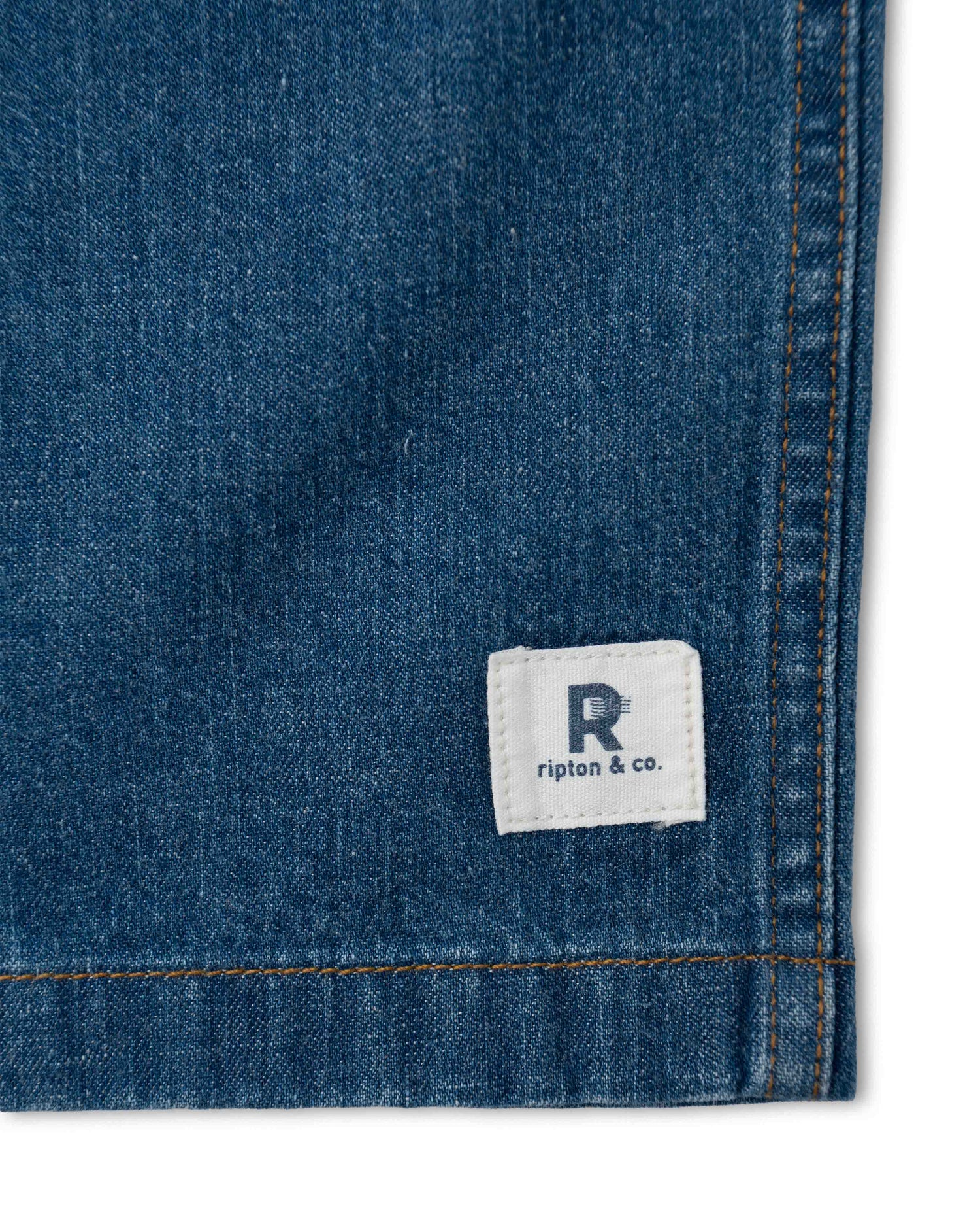 Close-up of a blue denim fabric with a Ripton & Co. label.