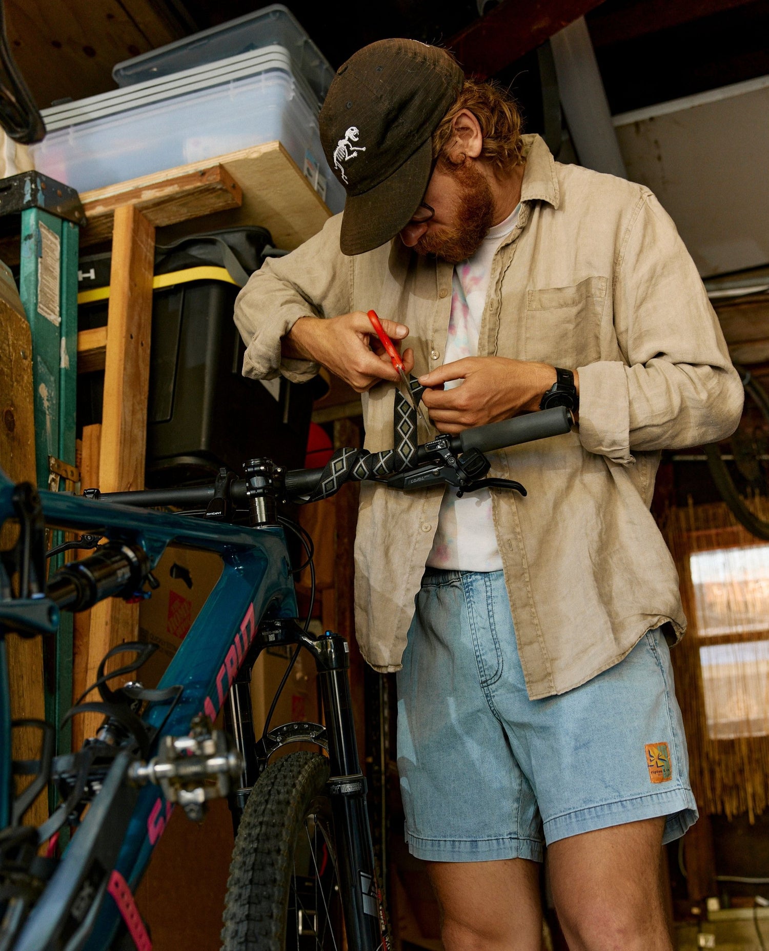 Man working on a bicycle inside a storage shed
