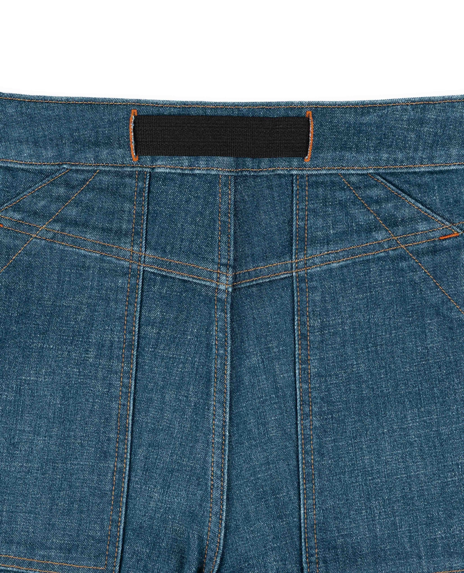 Close-up of blue denim fabric with a black label.
