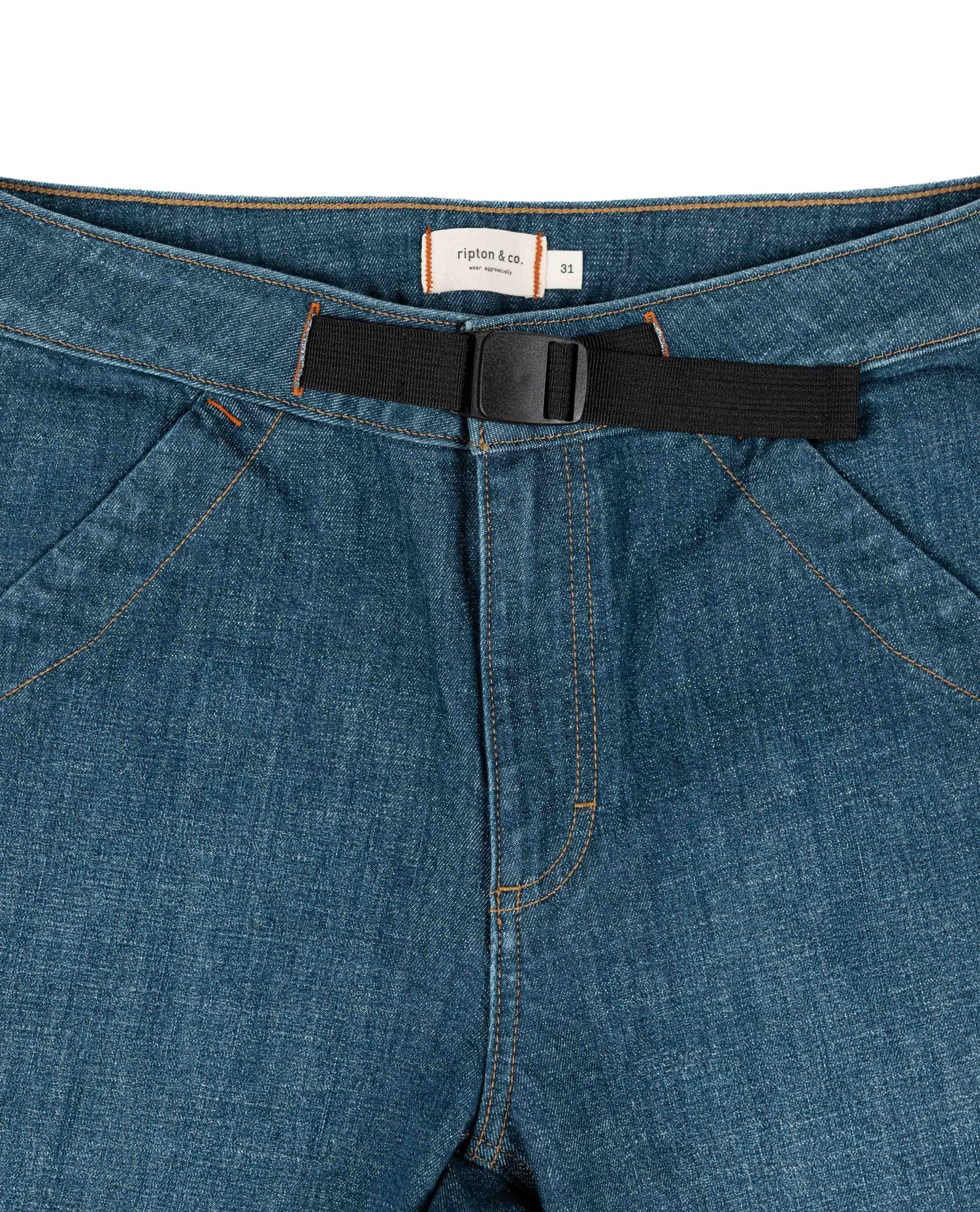 Close-up of blue jeans with a black belt and visible brand label on a white background