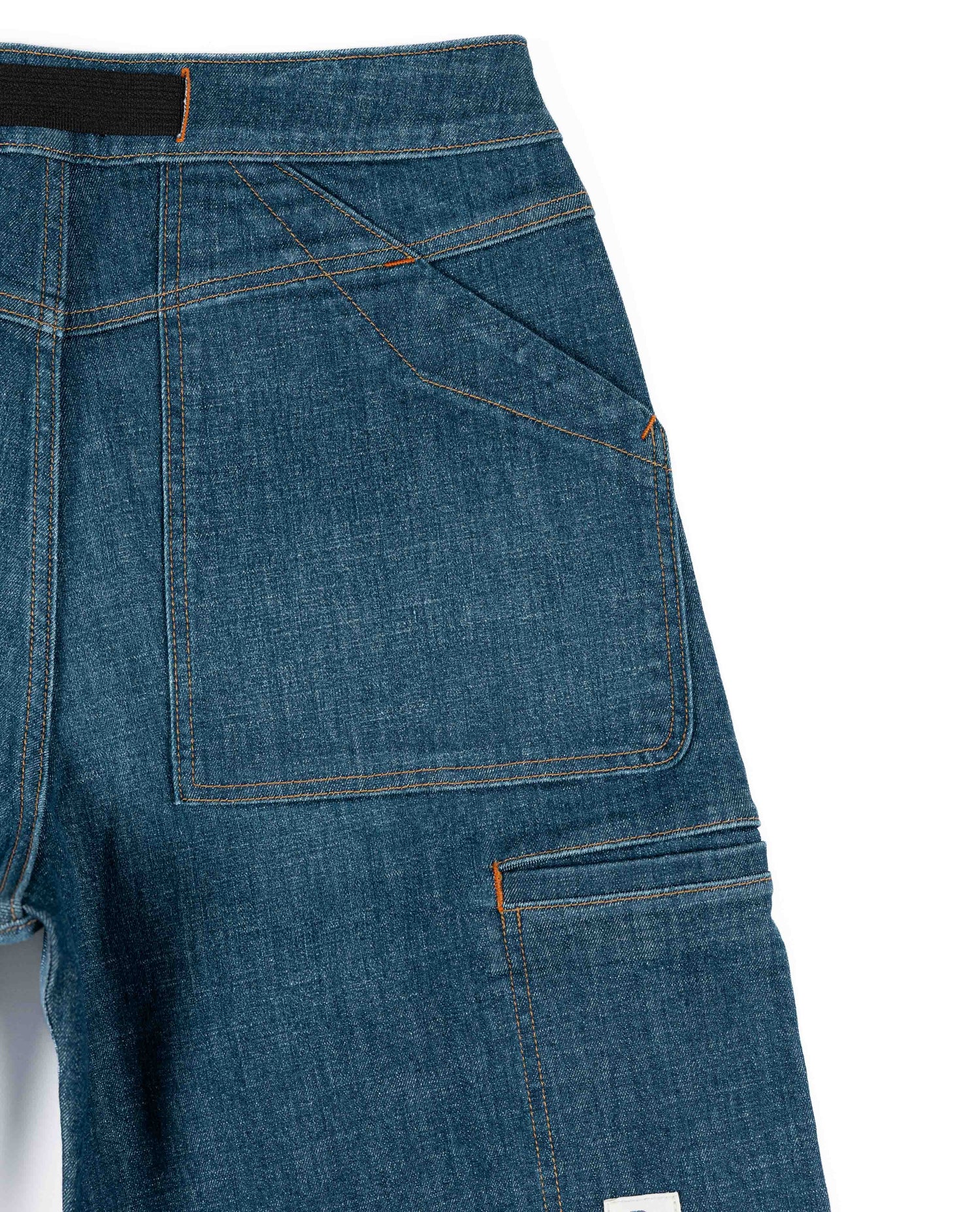 Close-up of blue denim pants with a white background
