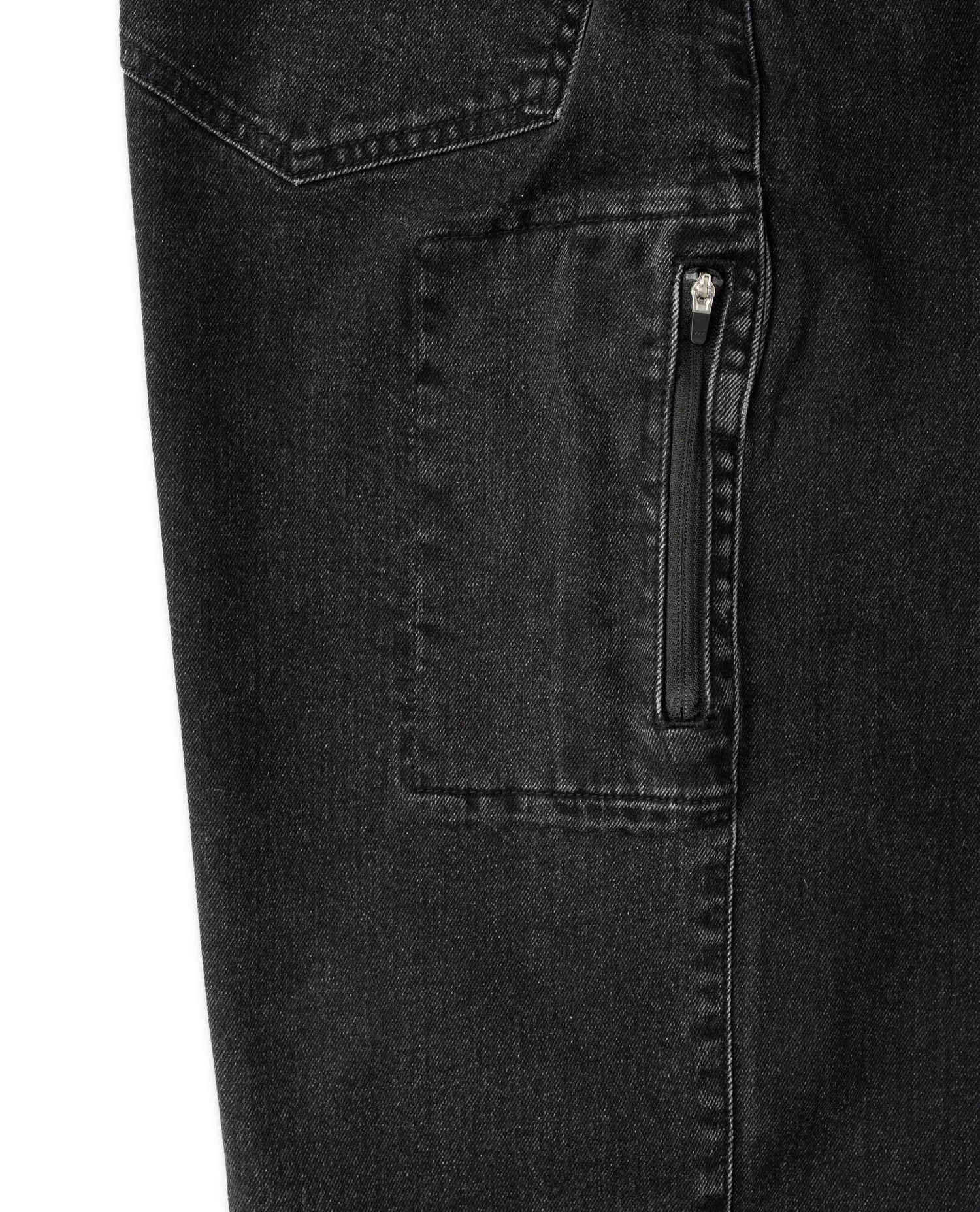 Close-up of black denim pants with a zipper pocket on a white background