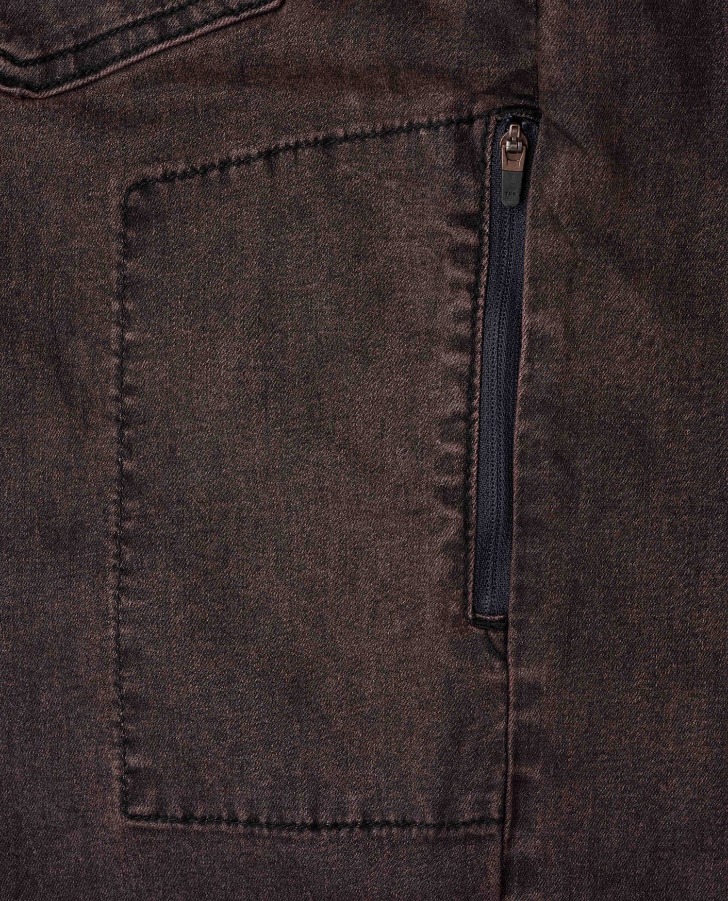 Close-up of a dark brown fabric with a zipper pocket